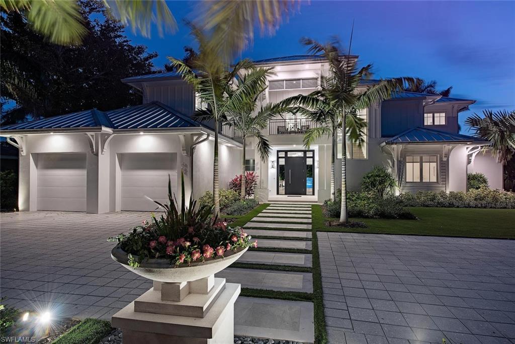Offering an ultimate vacation like feel this newly constructed Old Naples cottage style home was designed by MHK and built with meticulous detail and to exacting standards. Situated on an oversized south facing lot this residence offers a generous and light filled open floor plan which seamlessly flows to a resort like oasis including a 41' pool, spa, artificial turf yard, and a large covered outdoor living space with gas grill completely secured by automated screens and shutters.  The layout offers a first floor master bedroom with direct access to the outdoor living, first level study, and 3 en suite bedrooms plus living and loft space upstairs including a separately accessed cabana. Many custom details throughout, some of which include wide plank oak flooring, top end appliances and finishes, wet bar, LED lighting, electric and gas heat for pool, 2 tankless water heaters, and a 2 + golf cart garage which has space for car lifts if needed. Completed in 2017 this custom home offers an unrivaled combination of quality, location, layout, and value.