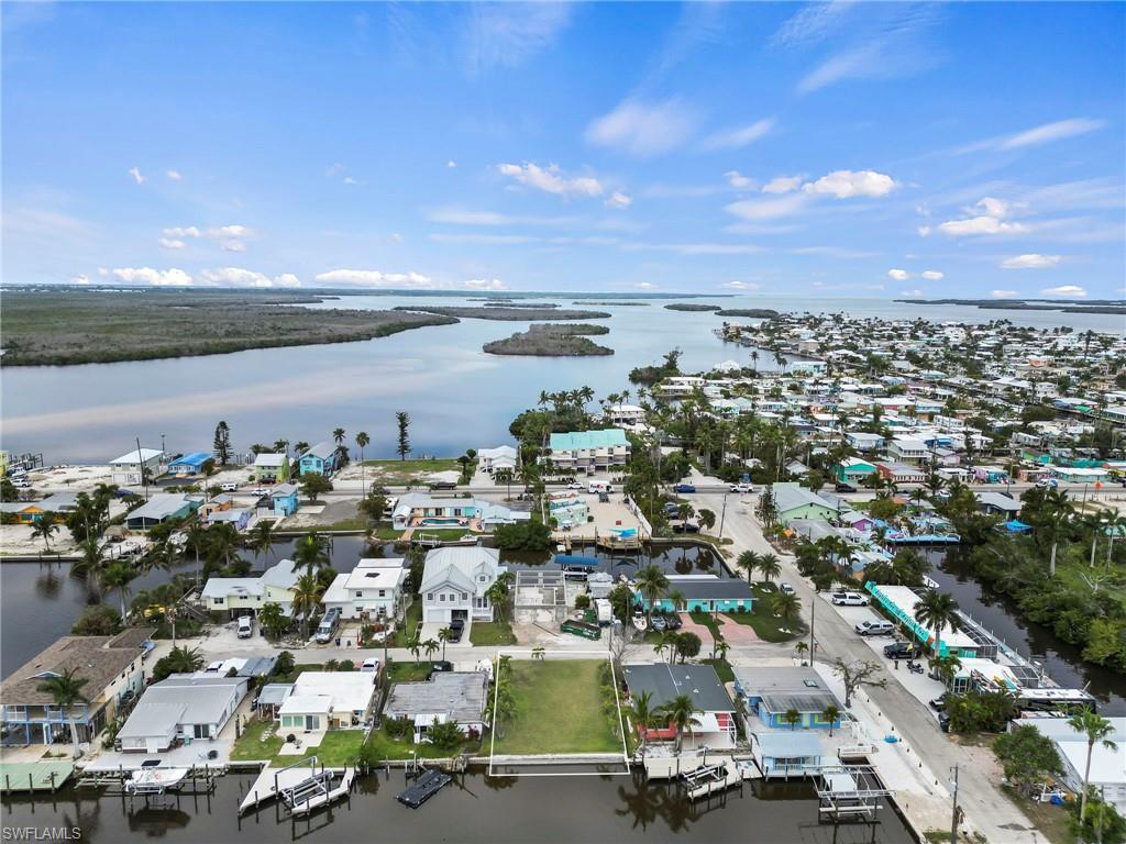 This CLEARED, VACANT and BUILDABLE lot with 50’ of CONCRETE SEAWALL is located on a QUIET, DEAD-END Street just a short TWO BLOCK walk to the HEART OF MATLACHA.  Matlacha is a charming fishing village is known for its artistic flair, seafood restaurants and island boutique shopping.  Capture dolphins and manatees swimming right from the backyard of your Florida dream home. This area is known for its spectacular boating. Just a short boat ride down the canal leads you to the Pine Island Sound and the Gulf of Mexico.  Prefer to island hop? Take the boat and head to islands only accessible by boat! Pack a lunch for Picnic Island.  Enjoy the views at Cayo Costa and world class fishing on North Captiva. Savor a cheeseburger in paradise at Cabbage Key. With world-renowned fishing throughout the area, cast a fishing line from the backyard and it might just bring in a snook, snapper or red fish to name a few. Boca Grande, the TARPON FISHING CAPITAL of the WORLD is minutes away by boat.  Cape Coral and downtown Fort Myers are just a short drive away. A dream home awaits you here in Matlacha ready to allow you to watch the colors bounce with the evening sunsets and enjoy the Florida lifestyle.