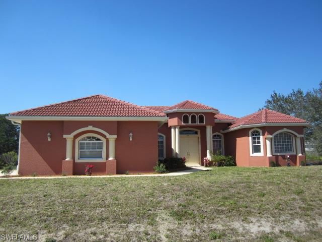 Rare one acre estate home. Spectular kitchen with beautiful granite tops including the huge island. Upgraded cabinetry, soft close drawers, stainless appliances and an exceptional backsplash! Tile throughout the home. Living room features built in entertainment cabinetry. Separate family/media room. Upgraded fixtures throughout. Den on master side of home, connecting to master bedroom. Perfect office or nursery. Oversized master bedroom with dual closets. Master bath features a giant spa tub and separate his and her vanities. Walk through shower. Formal dining room as well as a dinnette in the kitchen. Tiles lanai with a 1/2 bath. Three car garage for all the grown up toys!