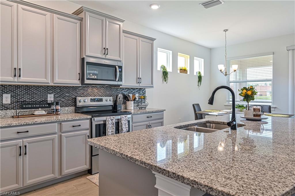 Wow, you will love this home! Location is premium with this beautiful 4 bedroom, plus den, 3.5 bath home including an awesome lake view. This DR Horton Ashbury floorplan has upgraded plank tile flooring, stainless appliances, designer light fixtures, granite counters, and an extra bath located on the covered lanai. Southern exposure and large back yard with plenty of room to add a pool. The highly sought after Lindsford community is gated with EZ access to shopping, restaurants, Gulf beaches, RSW Int'l Airport, new Top Golf sport/entertainment facility, Fort Myers Downtown River District, and so much more. Enjoy this resort style community with low HOA fees. Approximately 40 minutes to beautiful downtown Naples 5th Ave upscale shopping and dining. Don't miss out on this perfect opportunity to live in SW Florida!