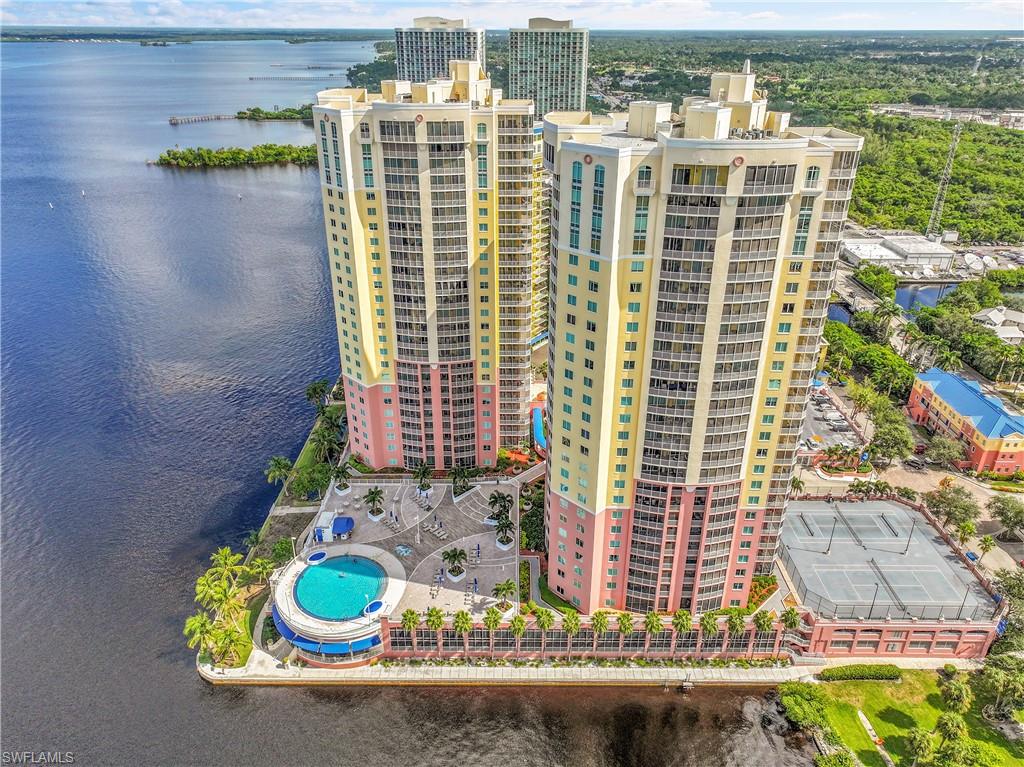 PRICE IMPRPOVEMENT!!!!  Time to own your slice of paradise!! Welcome to Riviera Fort Myers, where sophistication meets serene waterfront living. Perched on the 10th floor, this expansive residence captures breathtaking sunrise views over the Caloosahatchee River from its impressive wraparound lanai—perfect for morning coffee or evening relaxation. Offering over 1,700 square feet of thoughtfully designed living space, this largest floor plan features 3 bedrooms, 2 baths, and a private elevator entrance for the ultimate in privacy and convenience. The spacious galley kitchen showcases granite countertops, abundant cabinetry, and room to personalize with your own modern touches. Tile flooring flows throughout the main living areas, with soft carpet in the bedrooms creating a comfortable retreat. Two primary suites provide exceptional flexibility and comfort, while recent updates—including a new hot water heater—add peace of mind. Indulge in first-class resort amenities, including a newly designed pool and spa, state-of-the-art fitness center, lighted tennis and pickleball courts, BBQ and social areas, and a picturesque waterfront park ideal for soaking in spectacular riverfront sunsets. This is more than a home—it’s a lifestyle of leisure, luxury, and stunning water views, all just moments from the vibrant downtown Fort Myers River District. Walking distance to downtown Fort Myers River District where you will enjoy unlimited dining choices, entertainment, shopping and many monthly special events. Free trolley service during season from the front of the site to downtown 6 days a week. It's time to Live The Waterfront Life! Don't miss this fantastic opportunity!