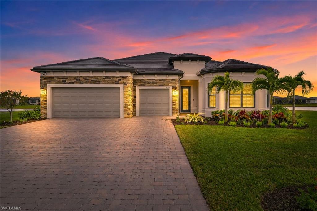 Welcome to luxury living in the highly sought-after community of Verona Village, nestled in one of Estero’s fastest-growing corridors. Perfectly positioned on an oversized nearly half-acre pie-shaped cul-de-sac lot, this exceptional lakefront residence offers one of the largest homesites in the entire community, providing breathtaking water views and an unmatched sense of privacy. Boasting over 3,000 square feet of thoughtfully designed living space, this  “RENOWN”  floor plan features 3 spacious bedrooms, a private den, 3 full bathrooms, 2 half bathrooms, and an oversized 3-car garage with a paver driveway and beautiful stone-accented exterior. Every bedroom offers its own en-suite bathroom, creating the perfect layout for family and guests. Inside, you’ll appreciate soaring ceilings, elegant crown molding, plantation shutters throughout, and premium flooring throughout  that enhances the home’s sophisticated design. The chef-inspired kitchen is truly the centerpiece of the home, featuring a massive center island, gas cooktop, KitchenAid stainless steel appliances, built-in wall oven and microwave, wine cooler, designer backsplash, quartz countertops, abundant cabinetry, and a generous walk-in pantry. As one of Estero’s premier natural gas communities, Verona Village provides the cooking experience today’s buyers desire. The luxurious primary suite serves as a private retreat with an expansive custom walk-in closet offering direct access to the laundry room for ultimate convenience. The spa-like primary bath showcases dual vanities, quartz countertops, and an oversized walk-in shower with seamless glass enclosure. Matching seamless glass shower doors continue throughout the home’s additional bathrooms, creating a cohesive upscale finish. Designed for effortless indoor-outdoor living, the expansive great room opens through pocketing sliding glass doors to the covered lanai, already pre-plumbed and equipped for a future outdoor kitchen. Whether entertaining guests or relaxing while taking in the spectacular lake views, this outdoor space offers endless possibilities. This lot is ready for your own touch with a custom pool if you desire, already featuring a pool bath and ready to go. With exceptional storage, luxury finishes throughout, one of the community’s most desirable oversized waterfront homesites, and access to Verona Village’s outstanding resort-style amenities, this remarkable residence truly offers the very best of Southwest Florida living.
