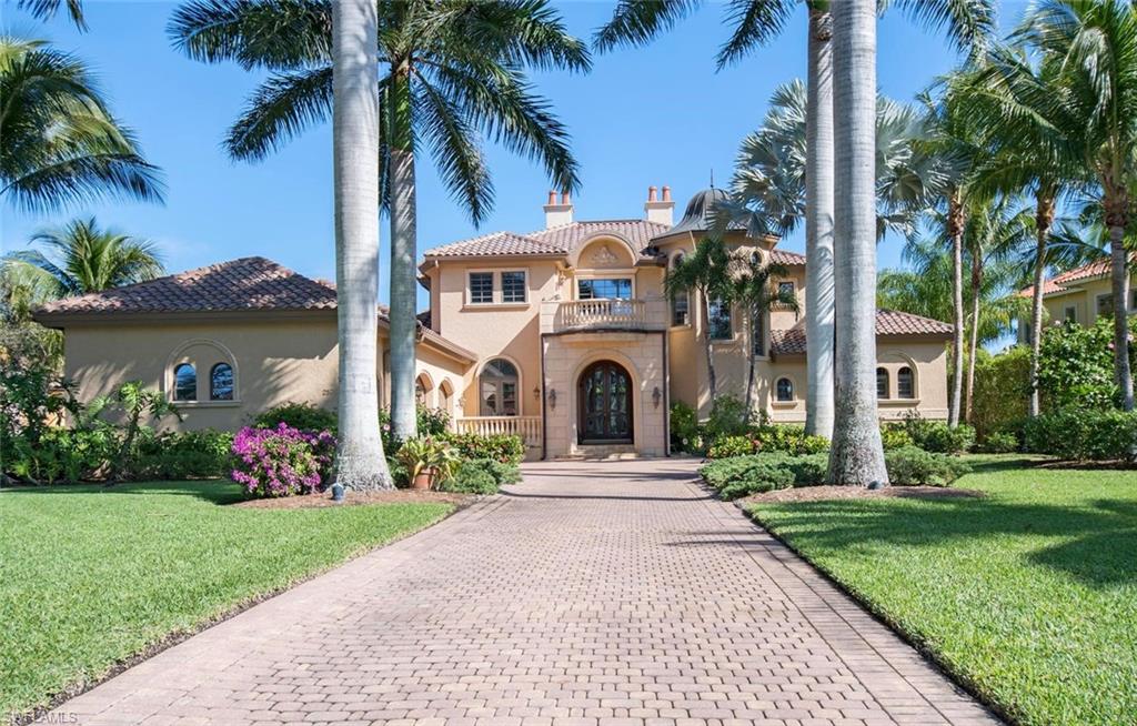 Exceptional custom estate located in the highly desired enclave of Escada at Tiburon that offers luxury & sophistication. This 5 bedroom + Den estate home sprawls across 6,334 Sq.ft. of living area. Upon entry into the two-story marble foyer, gaze through the wall of windows to the stunning infinity-edge pool that seemingly flows into the water feature lake to the rear and the golf course beyond. Pocketing sliding doors in the family room open to the covered lanai area with electronic screens, flat screen TV and summer kitchen. Built for entertaining, this home features a chef's kitchen, 2 dishwashers, Wolf gas range, wet bar with expresso coffee maker, icemaker and caterer's pantry. Expansive master suite with sitting area and large master bath. Beautiful study with custom wood paneling, guest suite and walk in wine cellar all on the first level. Second floor features large entertainment area, along with three additional bedrooms, all with balcony access, providing the ideal setting for your family and guests. Natural gas powers the generator, fireplace and stove. Medallion Membership valued at $70,000 is included.