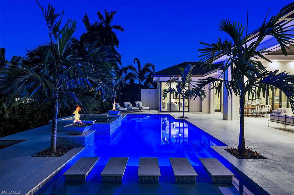 Centrally located in the Moorings, this new construction luxury home built by the highly sought after Knauf-Koenig Group is a Western exposure, 4 bedroom plus a bonus room and 5.5 bath home. Relax in the backyard and enjoy dramatic sunset views while cooking in the outdoor kitchen or swimming in the heated pool with a built-in spa adorned with gorgeous fire bowls perfect for an evening outside. Sunlight brightens the home through abundant windows and sprawling sliders giving you room to spread out and entertain with ease. The vaulted ceilings, hidden entertainment walls, gourmet kitchen, large butler’s pantry/catering kitchen, and luxury guest accommodations were all thoughtfully designed to enhance the Florida lifestyle, including enclosed Golf cart parking.