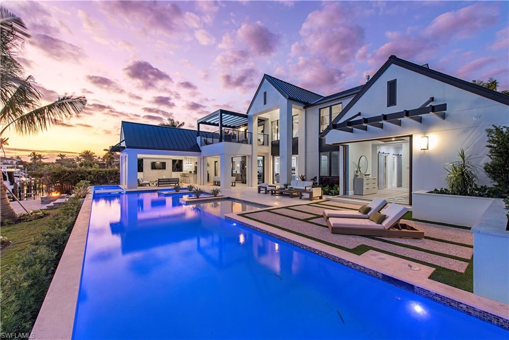 This stunning new custom home by Oakley Home Builders is the epitome of resort style living. Designed for a modern lifestyle, this home boasts state of the art finishes, an open floor plan that leads to the expansive outdoor living spaces that include 85 foot infinity pool & spa with swim up bar, Sedona Lynx gas grill, fire pit & lounge. The gourmet kitchen is complete with a cedar lined wine cellar, grand center island, double ovens, espresso machine, large dining space, butler’s pantry, and view-focused picture windows. The first floor en-suite master bedroom has large pocketing doors leading to the pool deck, his/her walk-in closets, spa-like bath with separate soaking tub, and dual vanity sinks. The master connects to an office with additional bedroom potential. The beauty continues upstairs to three en-suite bedrooms, second living area, and balcony access. Additionally, the property features an elevator, hard wood floors throughout, and a three-car garage. This ideal location is a short walk to the beach and to historic Third Street South. With 100 feet of frontage, this southern exposure home offers year-round sunshine and direct access to the Gulf of Mexico.
