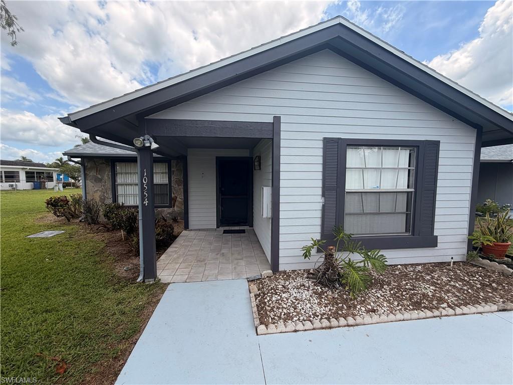 2 bedroom 2 bath villa end unit in Beacon Square with tile floors throughout and a screened in lanai and a storage room in the back of the unit and a community pool.