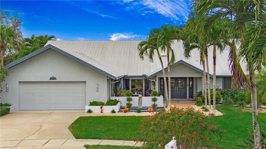 Discover tranquility in this Naples gem! Nestled on a quiet cul-de-sac in a low HOA community, this 4-bed, 4-bath home boasts vaulted ceilings, skylights, and a desirable split floor plan. The spacious kitchen, equipped with stainless steel appliances and gas cooking, is a culinary haven. Meticulously maintained with many upgrades, the residence features a large pool deck and lanai, perfect for outdoor gatherings. The beautifully landscaped yard, fully fenced with lush grassy areas, ensures privacy. Enjoy the saltwater pool and spa, heated by gas, making it an entertainer's dream. Centrally located to restaurants, shopping, and white sandy beaches, seize the opportunity for a serene lifestyle in this Naples haven.