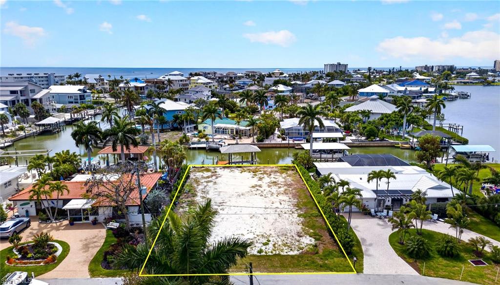 Attention Boaters & Beach Lovers! A wonderful opportunity to build your dream home on Fort Myers Beach in sought after Laguna Shores has just arrived!  Located on the South end of the Island, this prime building lot is ready & waiting to be transformed into the tropical oasis you’ve always imagined!  This property is ideally positioned on a wide canal that offers boating directly into the Bay and Gulf in minutes as well as access to white sandy beaches only steps away!   The newly built Big Carlos Pass Bridge is nearby to offer quick off-island access to Bonita Springs, Naples, RSW airport, fine or casual dining, shopping, entertainment & more!  The new bridge was also built with pedestrian and bike lanes for easy access to Lover’s Key.

This ready-to-build lot has a new, elevated to current code seawall, covered boat lift with captain’s walk, new 14,000 lb cradle kit, and a Jet Ski lift. Soil boring and survey are already completed.  Boat house and pilings are in excellent condition, only requiring shingle replacement.  The property also includes an irrigation well. Survey, Soil boring test, Seawall Contract, Cradle Invoice and potential home design specs are all available upon request. Why wait?  Call today to start turning your dream into reality!