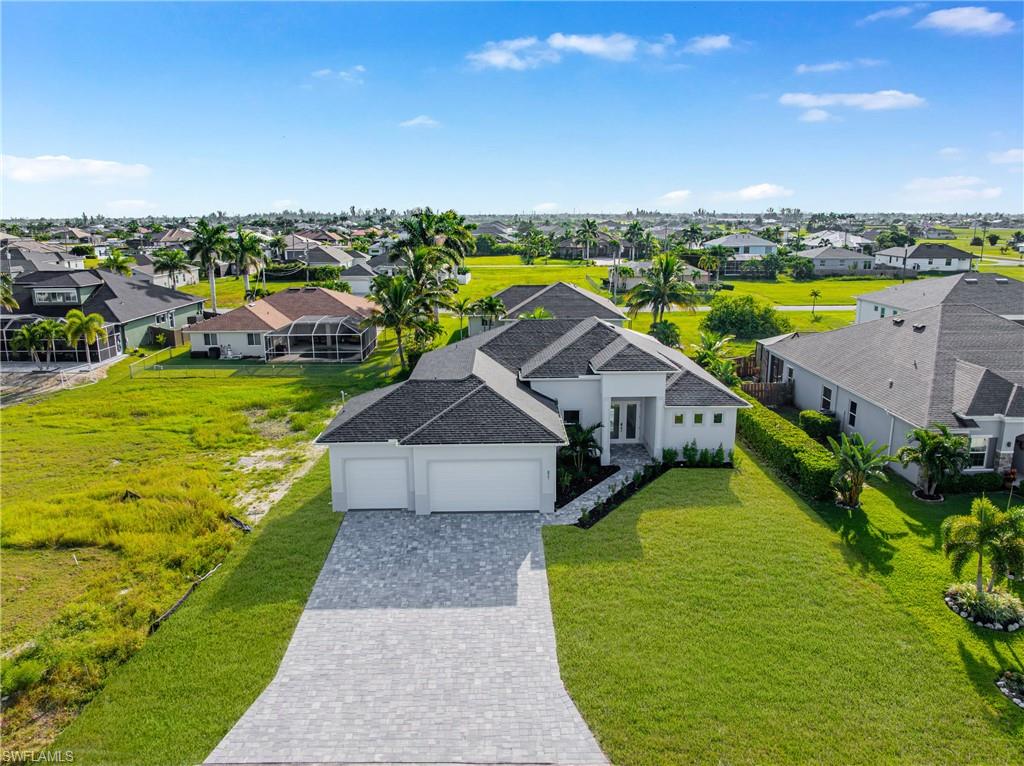 BRAND NEW HOUSE NEVER LIVED IN....Welcome to this stunning 3-bedroom + den, 3-bathroom pool home offering 2,057 square feet of elegant living space in one of Cape Coral’s fastest-growing areas. Designed for comfort and sophistication, this home showcases a bright open floor plan, high ceilings, and sleek porcelain tile floors that reflect natural light throughout. At the heart of the home, the chef-inspired kitchen features a large waterfall-edge island, modern white cabinetry, stainless steel appliances, and stylish pendant lighting—perfect for entertaining guests or enjoying family meals. The spacious great room opens seamlessly to the lanai, creating an effortless indoor-outdoor living experience. Relax in the private primary suite, complete with a Elegant bathroom featuring dual vanities, a walk-in shower, and elegant finishes. Each guest bedroom offers generous space, while the flex den can serve as a home office or an additional guest room. Step outside to your sparkling pool and covered lanai, perfect for enjoying Florida’s sunshine and warm evenings year-round. Built with hurricane impact windows and doors, this home provides both safety and energy efficiency. Located just minutes from the up-and-coming Seven Lakes Project, you’ll enjoy the convenience of future shopping, dining, and recreation right at your doorstep—all while living in a peaceful residential neighborhood. This is more than a home—it’s a lifestyle of modern Cape Coral living at its finest.