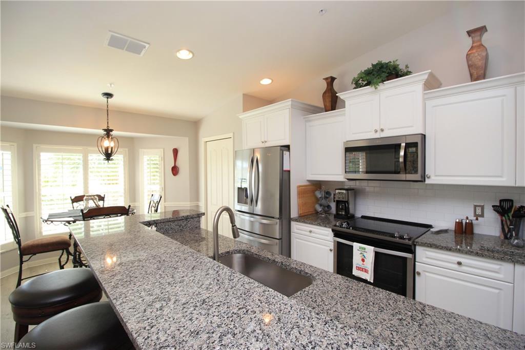 BEAUTIFUL 2nd floor Verranda with 1-car detached garage, features open concept family room & kitchen, vaulted ceilings with expansive lake views, front & back screened lanais, custom Plantation Shutters & updated flooring throughout. Newer kitchen appliances with plenty of cabinets & granite counter space, a counter height bar & separate breakfast nook for additional seating, & separate dining area ideal for entertaining. The den features custom built-ins for office space with queen Murphy bed. The 2nd bedroom also features custom built-ins. Master bedroom with 2 large closets & en-suite with double vanity. Desirable No Naples bundled golf community of CYPRESS WOODS GOLF & COUNTRY CLUB features an 18-hole championship course with a putting green & aqua range. Located near many of the area's attractions & conveniences, including county & state beaches & preserves, the Mercato, shopping & restaurants, places of worship, schools, medical care, I-75, & RSW Airport.  Community amenities include a clubhouse with an award-winning restaurant & bar, large heated community pool, lap pool, spa, 4 lighted tennis & pickle ball courts and fitness facilities with a studio for aerobics & yoga.