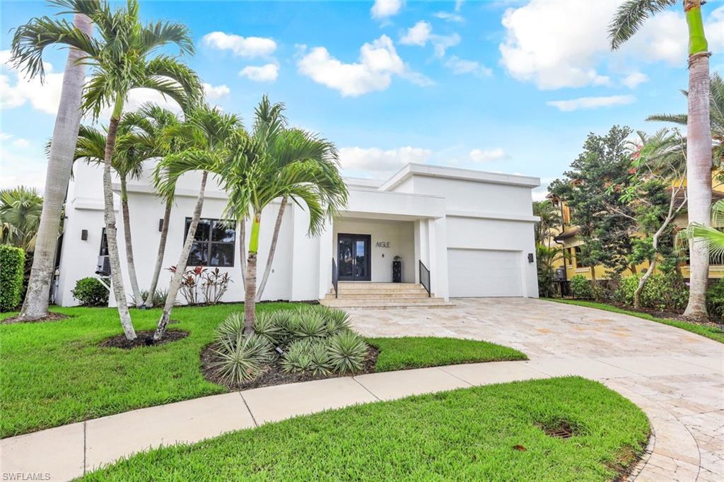 A TRUE ONE OF KIND HOME! Located in the highly desired Tiger Tail beach neighborhood. This contemporary home was thoughtfully designed (build 2012) and decorated by its current owner for seamless indoor and outdoor living. With the top of line furnishings many imported from Italy- a custom billiards table, antiques and curated works of art. Upon entering you are greeted by soaring 18 ft ceilings with sky lights to provide ambient lighting throughout the day. a wall of sliding glass opens to your expansive pool deck and lovely views with over 170ft on water. The kitchen is designed to entertain with an oversized island and seating for 8 top of line appliances, built in Viking Appliances, and a dedicated wine fridge. 4 bedroom suites - 3 located on the first floor and one on the second floor. Stone floors throughout- the first floor Primary suite has an oversized walk in closet- freestanding tub and walk in shower - the second Primary suite on upstairs features a wall of sliding glass to take in the views as well as access to a private terrace. Fantastic direct boating access to the Gulf of Mexico. Neptune boat lifts (13 & 30,000 lb) and car lift. This home can be sold turnkey!
