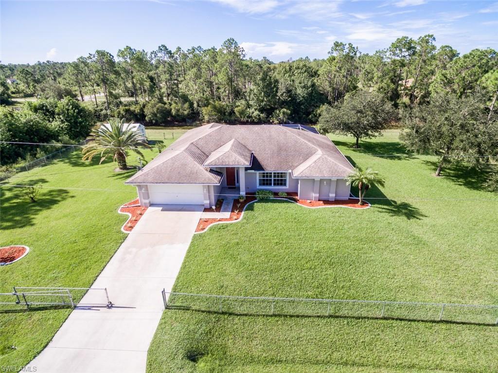 Paradise has been found in this custom pool home that sits on a tranquil 1/2 acre of land. This home has had only 1 single owner and has been meticulously taken care of. Freshly painted exterior and most of the interior as well. 
Enter through the front door and will be welcomed by a charming foyer. There is a living room, great room, dining room, master bedroom all have brand new wood-like floors. Tile is in the wet areas and the 2 guest bedrooms have plush carpet. The kitchen sits in the middle of this ranch style home which is great for entertaining. This home has many upgrades such as a newer A/C and hot water heater. The 2 car garage is extra long to fit your larger vehicles and there is also a Generator Hook-up in the garage. 
Relax on the lanai or in the huge refreshing pool. The lanai on this home would suit the large parties and holidays! 
There is a shed on the back corner of the property and the entire property is fenced with a gate in the front also.