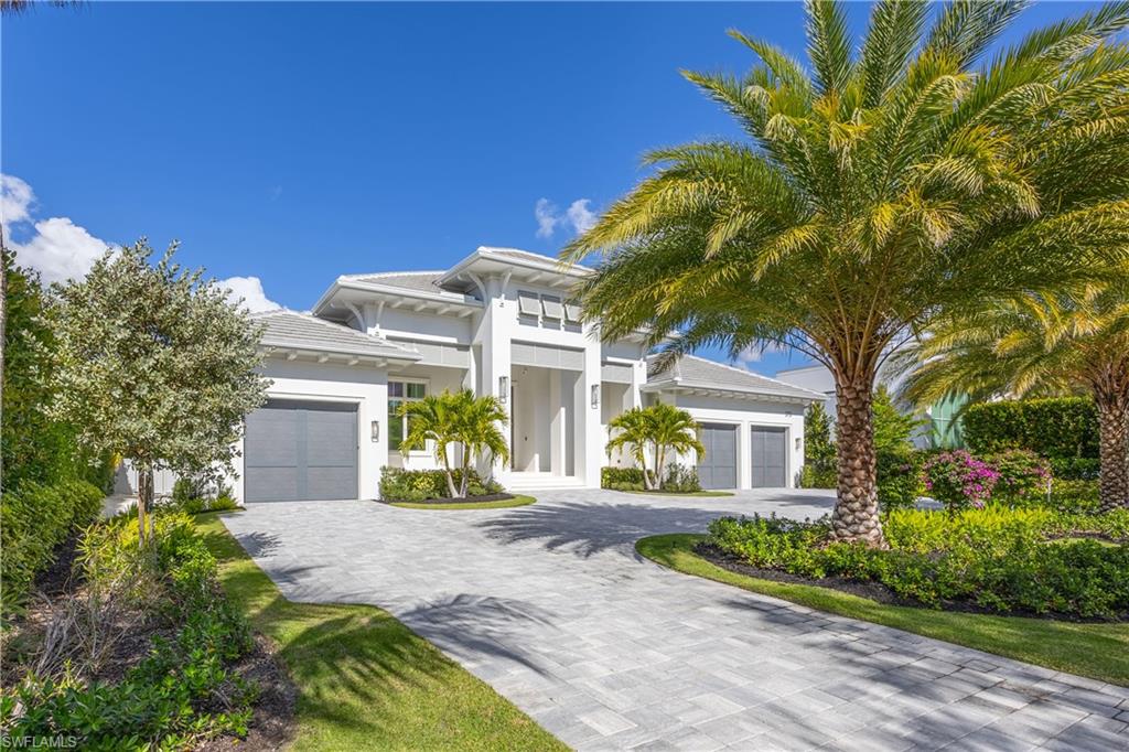 Setting a new benchmark for luxury living, this newly constructed architectural masterpiece is an exceptional offering in the prestigious Moorings neighborhood. Positioned on a tree-lined street with tranquil green space across the way, this sophisticated four-bedroom plus den, 4.5-bath, three-car garage residence delivers an unparalleled blend of elegance, comfort and functionality. From the moment you arrive, the home’s striking curb appeal and 10-foot custom iron entry door set the tone for what lies beyond. The grand foyer welcomes you with abundant natural light, soaring vaulted ceilings and seamless indoor-outdoor transitions. Thoughtfully designed architecture paired with bespoke designer selections by Anna Roze Design Studio make this residence one of a kind. The expansive open floor plan is adorned with 10-inch white oak flooring throughout, custom solid wood cabinetry and doors, and curated designer lighting. A spacious and inviting leisure room creates a setting for intimate gatherings and grand entertaining. The chef’s kitchen is a statement of beauty and function, featuring a large marble island with bar seating, white custom cabinetry, and Wolf and Sub-Zero appliances. A charming breakfast nook with a custom built-in bar, mirrored accents, cabinetry and refrigerator drawers adds style and convenience. The adjacent dining area showcases a floor-to-ceiling glass wine room, offering a stunning display ready for your personal collection. The luxurious primary suite is a private retreat overlooking the pool, complete with a spa-inspired bath and generously sized custom closets. Three additional en-suite guest bedrooms, a pool bath, and an elegant powder room provide comfort and privacy for family and guests alike. A beautifully designed office, framed by classic French doors and filled with natural light, offers an ideal work-from-home sanctuary. Outdoor living is equally impressive, designed as a private oasis. Enjoy a saltwater pool and spa, covered dining area with a fully equipped outdoor kitchen, leisure space and fireplace, ideal for entertaining year-round. Whether envisioned as a full-time residence or a seasonal escape, this home offers an extraordinary lifestyle. Go to or take a golf cart ride to Venetian Village Shops for world-class dining, enjoy a short drive to Fifth Avenue and take advantage of exclusive Moorings private beach access, all just moments from your door!