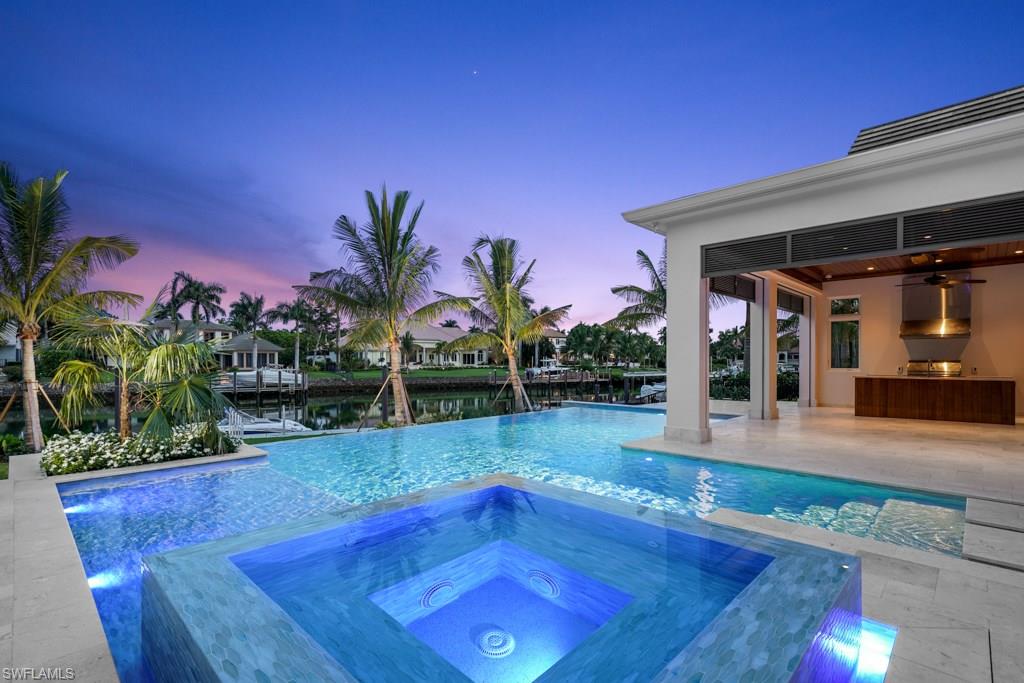 Introducing the Harbour Hideout, an incomparable transitional style retreat in Naples’ finest luxury waterfront community of Port Royal. Penned by award-winning Jon Kukk and meticulously constructed by Refined Builders, this home has been designed to maximize the property’s oversized profile and ideal southern exposure. The 6 bedrooms and study with 6 full bathrooms flow with the timeless motif and are accented by hand selected finishes from Lisa Kahn. Duchateau hardwood floors grace the entire residence. The chef’s style kitchen features Wolf and Sub Zero appliances framed by exotic marbles and double island with bar seating. First floor master bedroom wing boasts two large his and her closets with custom millwork by Soho for unmatched quality. Separate guest cabana, large motor court & 4 car garage add to the home’s amazing profile. The great room and family room areas lead to the enchanting outdoor living area with resort style pool and spa, full outdoor kitchen and Bellingham concrete floating dock with beautiful vistas over Harbour Channel. Whole home generator, state of the art Elan smart system and Port Royal Club eligibility make the Harbour Hideout a generational retreat.