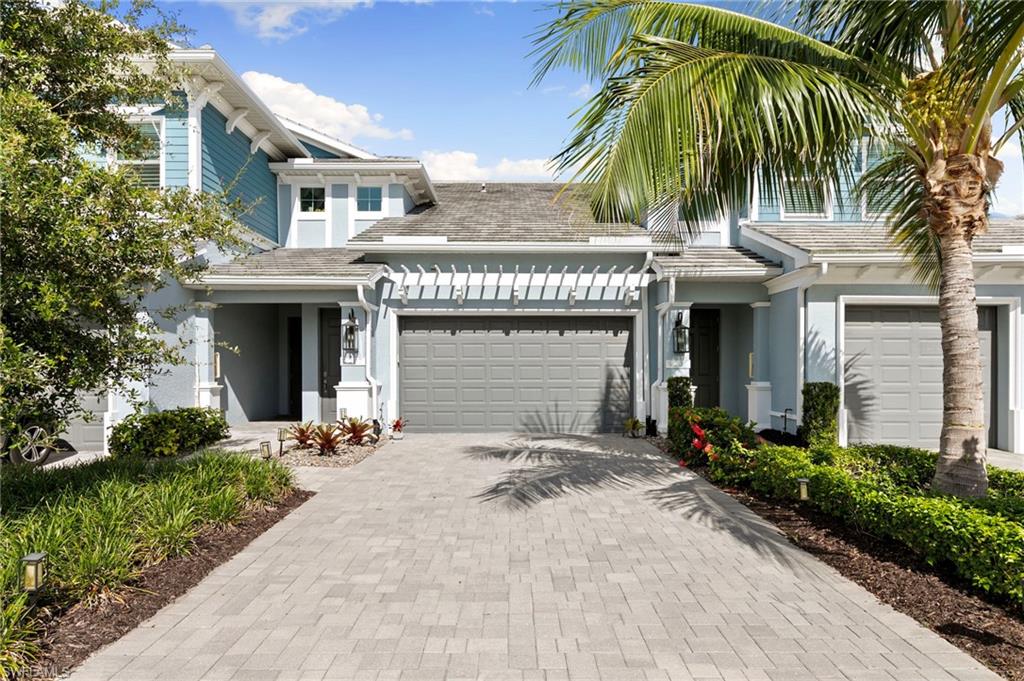 Experience the best of the Naples lifestyle from this beautifully upgraded coastal contemporary coach home in the highly desirable Midtown Naples area. Ideally located just minutes from downtown Naples, world-renowned Gulf beaches, Waterside Shops, Mercato, championship golf, pickleball, waterfront dining, and endless entertainment, this move-in-ready residence offers the perfect blend of luxury, convenience, and everyday comfort.

Designed for effortless Florida living, the spacious open-concept floor plan invites you to gather with family and friends or simply relax after a day at the beach. A custom built-in electric fireplace and 85-inch television create a stunning centerpiece, while expansive living spaces flow seamlessly for entertaining and everyday enjoyment.

The designer kitchen is both stylish and functional, featuring upgraded countertops, custom cabinetry, designer lighting, a decorative pantry door, and a convenient dry bar—ideal for hosting happy hours or preparing meals before heading out to enjoy everything Naples has to offer.

Throughout the home, elegant tile and luxury vinyl plank flooring, plantation shutters, a custom closet system, and impact-resistant windows provide both beauty and peace of mind. Step onto the private screened lanai to enjoy your morning coffee, unwind with a sunset cocktail, or simply soak in the peaceful surroundings.

A spacious two-car attached garage and thoughtfully curated high-end finishes complete this exceptional residence. This coach home is an outstanding opportunity for those seeking a full-time residence, seasonal retreat, or investment property in one of Naples’ most convenient locations. Enjoy easy access to downtown Naples, Fifth Avenue South, Third Street South, white-sand beaches, luxury shopping, fine dining, and everything that makes Southwest Florida one of the nation’s most sought-after destinations.