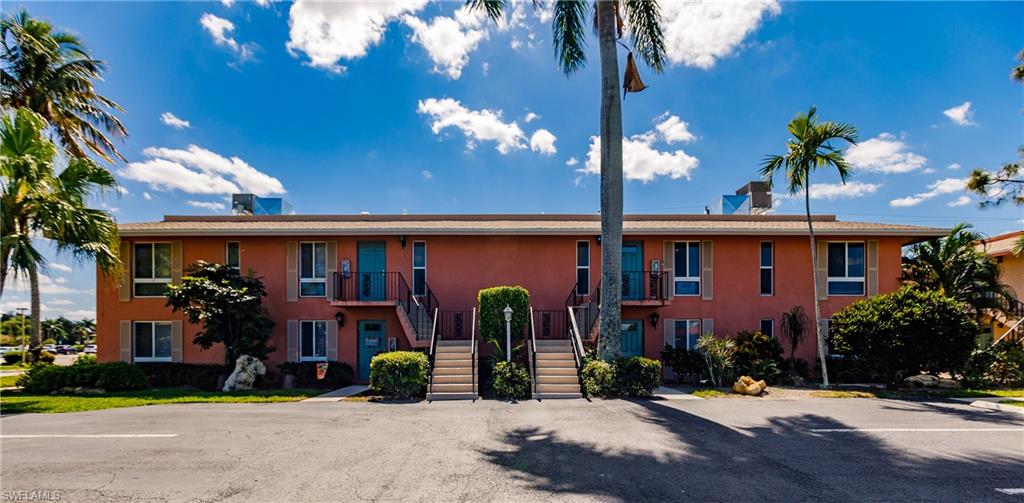 This 2 bedroom 2 bath second floor condo is overlooking the 1st Tee of the Palmetto course. Walk down private stairway from your extended lanai onto course and putting green.  EXTRA STORAGE on side of building. So close you are walking distance to everything.  Kitchen and bathrooms have been updated. New air conditioner and water heater.Open your large, IMPACT-RATED GLASS, sliding doors onto your spacious lanai and sit back and enjoy Florida’s lovely weather. This is part of a BUNDLED GOLF community with 2 Golf courses (Par 70 & Par 55) a Clubhouse, Pro shop, 9 pools, 10 Tennis Courts, Bocce ball courts & The 19th Hole Bar & Restaurant.  Located just a 10-minute, 3.5-mile drive to DOWNTOWN 5th AVENUE and its WORLD-RENOWNED BEACHES or a 30-minute drive to the center of MARCO ISLAND and all it has to offer.