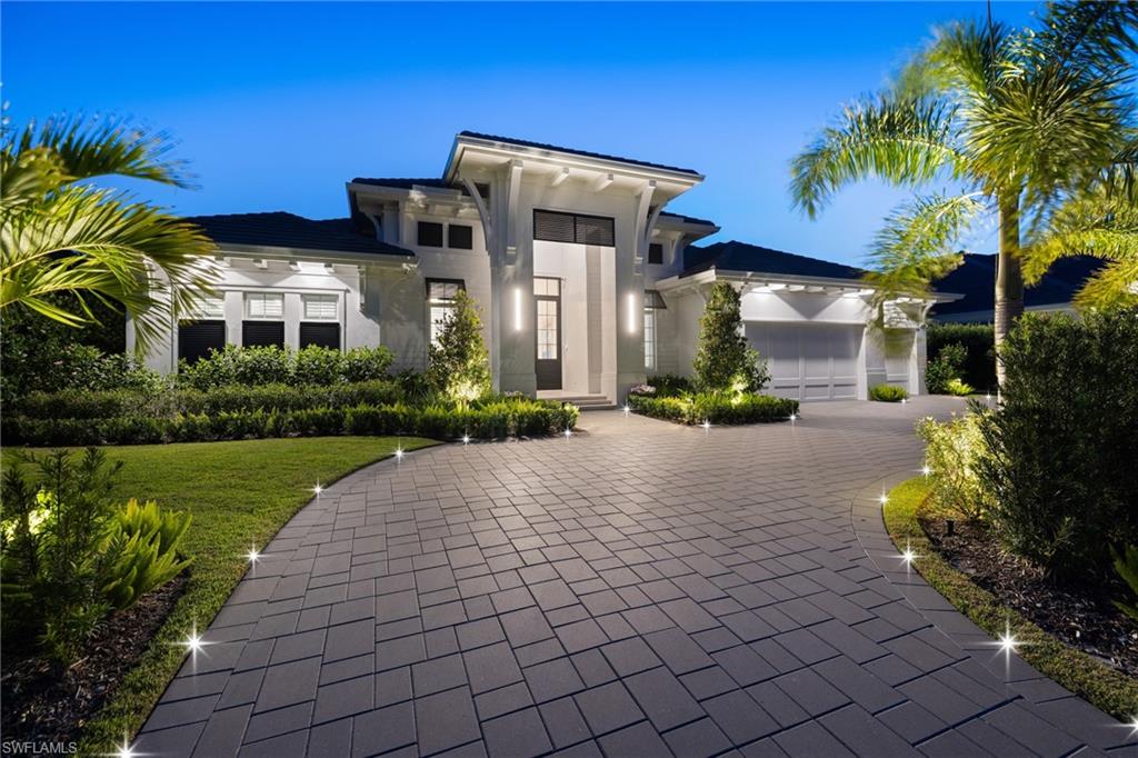 The home immediately captivates with grand scale and breathtaking sightlines through expansive 10 ft high glass sliders with the oversized lanai and lush private backyard beyond. Sprawling across a single level, this 2024 custom residence showcases a timeless design, luxurious finishes and an expansive outdoor oasis that truly sets it apart.  Set on an oversized west facing lot, the backyard unfolds as a resort-style retreat designed for both relaxation and entertaining. Lush tropical landscaping enhances the setting, while the open-air living area seamlessly connects to a covered lanai featuring a fully equipped summer kitchen, whitewashed wood ceilings, gas fireplace, electric screens and shutters and bar seating—perfect for effortless indoor-outdoor living. Inside a light-filled interior reveals a thoughtfully designed open-concept living space including 5 bedrooms, an office, 5 full baths and a poolside half bath, all harmoniously designed with sophisticated finishes.  The great room stuns with soaring 13’-14’ ceilings and Legno Bastone flooring throughout and anchored by the chef’s kitchen with a grand quartzite island, Subzero and Wolf appliances and a custom bar area to match complete with Subzero undercounter wine storage. The primary suite offers a total escape with dual walk-in closets, a spa-like bathroom featuring stone flooring, a free-standing soaking tub, refined lighting and a striking walkthrough shower with sleek finishes and crisp feature wall. To complete the experience, residents will appreciate the Sonos sound system, whole home generator, smart home capabilities and so much more.  Just a mile away, Moorings residents can enjoy eligibility to join the private Moorings Beach Association, offering beach parking and exclusive events.