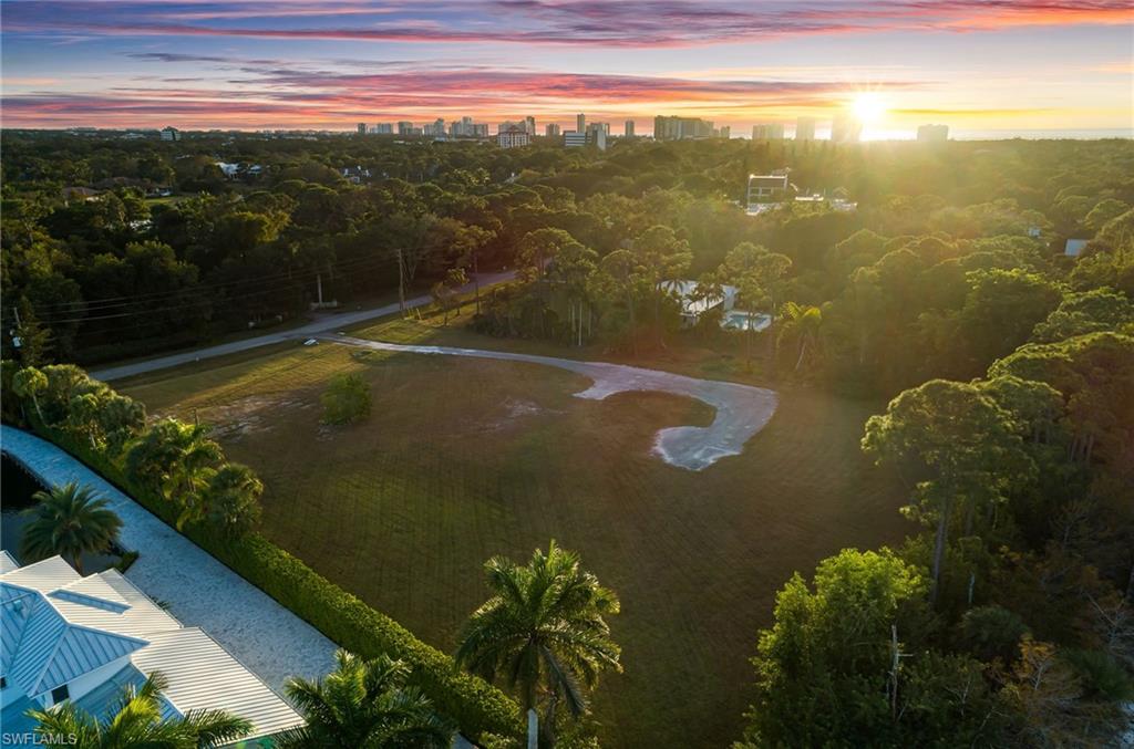 An exceptionally rare offering, this 1.75± acre homesite at 157 Center Street in Pine Ridge represents one of the last and largest estate lots available in this coveted Naples location. Perfectly positioned on a quiet dead-end street, the property combines privacy, scale, and serenity in a way that simply has not been available in this neighborhood for many years. Completely cleared and truly ready to build, this site allows you to bypass the time, cost, and uncertainty of demolition and preparation, moving straight into the design and construction of your dream estate home. With an impressive wide frontage and a deep, park-like setting, the property can easily accommodate a grand single-level residence, generous garage space, resort-style pool, guest house, and expansive outdoor living areas. Pine Ridge is renowned for offering some of the largest residential lots, just minutes to Naples’ world-class beaches, shopping and dining of Mercato and Waterside Shops. Opportunities of this size and caliber, in this prime location, have become virtually nonexistent, making this property a true standout for both end users and savvy builders seeking their next signature project.