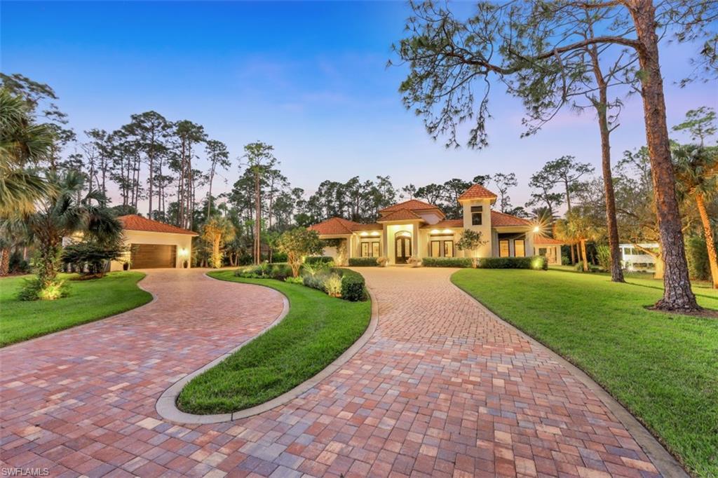 Welcome to this one of a kind Estate Home in beautiful Logan Woods! A true retreat boasting 3.69 acres, this home was envisioned through a designer's eye, showcasing luxury details, thoughtful spaces, and the finest finishes. As you enter the gorgeous 12’ custom iron front door, you are welcomed with volume ceilings in the entryway and 12’ ceilings throughout. Turkish marble tile is found throughout the home with beautiful wood floors in each bedroom. The designer kitchen features custom cabinets by Kitchen by Clay, exotic quartzite donning a 2” island countertop, luxury appliance package including Bosch and Cafe Series, built in Sub-Zero wine tower with two beverage refrigerators, and full extension deep drawers throughout the kitchen. The exquisite outdoor living space features a gorgeous pool and spa overlooking the spacious lawn, and a lovely pool pavilion with Alfresco appliances to complete the outdoor kitchen. Additional notable features include impact windows & doors, designer fans & chandeliers, 24’ pocket sliding doors, new roof installed in 2020, fencing around the entire estate, and a security gate with keypad entry.