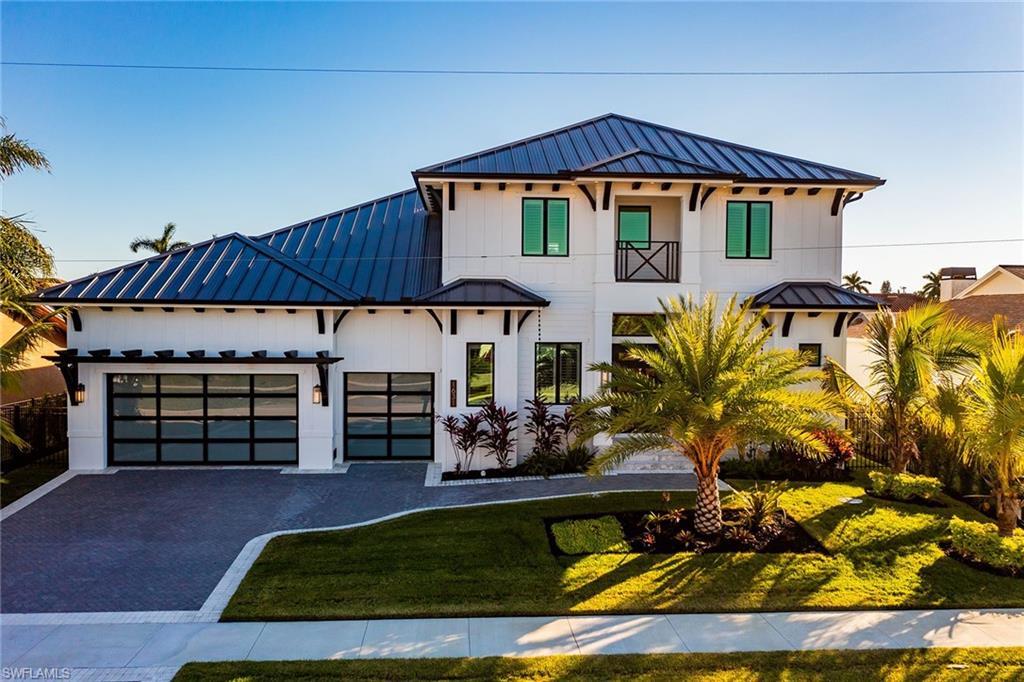 Experience luxury coastal living at its finest in this exceptional 6-bedroom, 5.5-bath waterfront home on Marco Island. Perfectly positioned on a southern exposure lot with wide water views, this two-story residence offers quick Gulf access through Roberts Bay, ideal for boating and water recreation. The property features an oversized three-car garage, a private dock equipped with boat and Jet Ski lifts, and a resort-style outdoor area with a heated pool, spa, and spacious entertaining areas. Inside, enjoy ample, elegant living space with high ceilings, custom cabinetry, a gourmet kitchen, and generous room layouts designed for comfort and style. European white oak flooring, built out and finished bedroom closets, bathrooms tiled to the ceiling and high end appliances all speak to the level of finish this residence provides. Additional features include a whole-home generator, professional tropical landscaping, and a thoughtfully designed floor plan perfect for hosting guests or enjoying peaceful waterfront serenity. Located just minutes from Marco Island’s pristine beaches, award-winning restaurants, boutique shopping, and parks, this home blends elegance, functionality, and the ultimate Florida lifestyle. Whether you're seeking a full-time residence, seasonal retreat, or luxury vacation rental opportunity, this is a rare chance to own in one of Florida’s most desirable boating communities.
