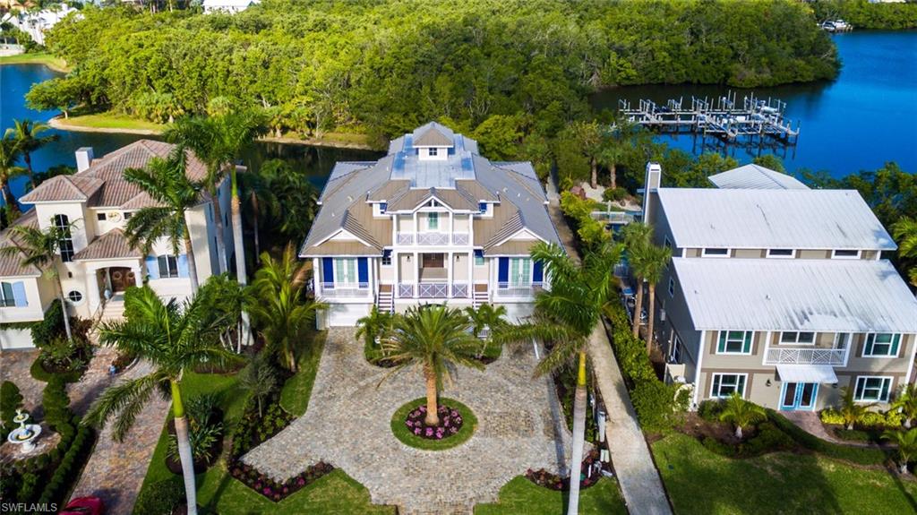 Rarely available waterfront home, built in 2018 by highly regarded Potter Homes, now available in Barefoot Beach! Perfectly located in Southport on the Bay in Barefoot Beach, a double-gated North Naples/Collier County beach & boating community, with private Gulf-access boat slip & deeded resident only beach access steps away. Delight in gorgeous Bay & lake views from the entertainment deck with lounging area & a pool/spa. Steps away from private gulf-access boat lift in the Southport Marina. Open floor plan with dual master suites, great room with tray ceiling accent & pocketing sliders to showcase the stunning water views. State-of-the-art features include PGT impact glass windows/sliders, Lutron smart lighting system, 6-zone speaker system with Sonos, garage with room for 4+ cars, private elevator & more. Coastal contemporary with white oak floors & designer furnishings/décor negotiable. Chef’s kitchen with eat-in island, granite counters with subway backsplash, custom cabinetry & Thermador professional appliances. Spacious & private master suite with sitting area, its own waterfront lanai, generous dual walk-in closets & spa-like en suite bath. A showcase of visionary design.