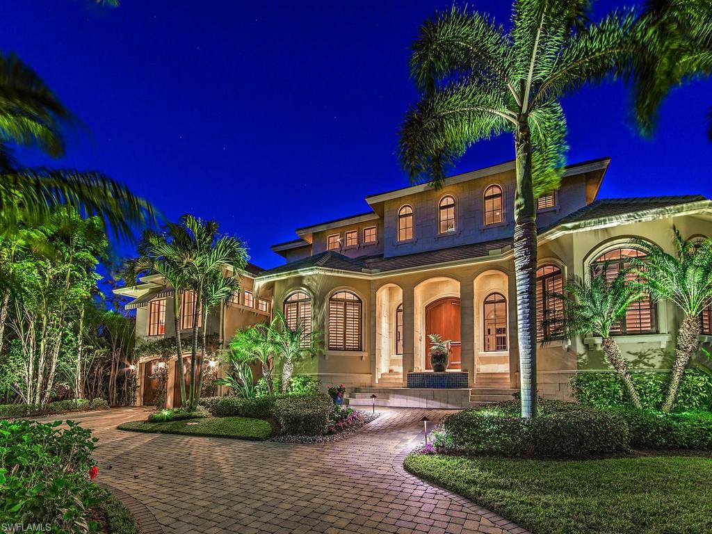 THIS EXQUISITE ROYAL PALM AQUALANE ESTATE is the definition of waterfront luxury! Incomparable attention to detail throughout this five bedroom + Den home designed by Falcon Design Inc. Walk to Naples beaches or to Third St Shopping & Restaurants! Located on a prime, deep wide water lot with a rare cut-in, covered boat dock which includes a 20,000 lb boat lift. This tastefully decorated home boasts seven and half baths, magnificent master suite, office with full en suite, wine cellar, living room with gas fireplace, upper and lower level family rooms. The large gourmet kitchen has top of the line Wolf and sub-zero appliances. A unique guest wing offers two bedrooms each with private sitting areas and en suite baths. The two upstairs bedrooms and family room each have French doors leading out to the expansive second floor covered balcony overlooking the water. Tranquil outdoor seating in the lanai surrounds a grand gas fireplace and outdoor dining is a breeze with the summer kitchen. Royal palms flank the infinity-edged pool with 40 ft. lap lane and spa. Relax on the 150 Ft. wide canal’s edge on the 80 foot extra wide dock which is Perfect for your 80 ft. Yacht! PARADISE FOUND!