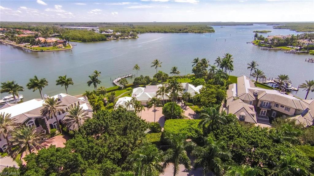 L.2014 - Magnificent, panoramic views from this exceptional homesite boasting 317 ft on Naples Bay! This is a LAND opportunity, located on the southern tip of Galleon Drive, and is a very special location. What will one day be built on this large homesite will be without equal! Recent price reduction makes this a very appealing Port Royal lot. While planning your dream home, enjoy the charming, quintessential, older Florida style home with 5 BR + den and almost 5,500 Sq.Ft. of living area. Guest quarters with a separate entrance has 1 bedroom/bath, living room and kitchen, ideal for caretaker. The covered lanai, custom pool and beautiful landscaping provide great entertaining areas both inside and out. Dock your boat at your back door and enjoy endless hours of pleasure cruising, fishing, wake-boarding and sunset cruises! Ownership qualifies for associate membership at the prestigious Port Royal Club, for world class dining, tennis, fitness and spa facilities. Come to paradise and live the lifestyle you deserve in Naples!