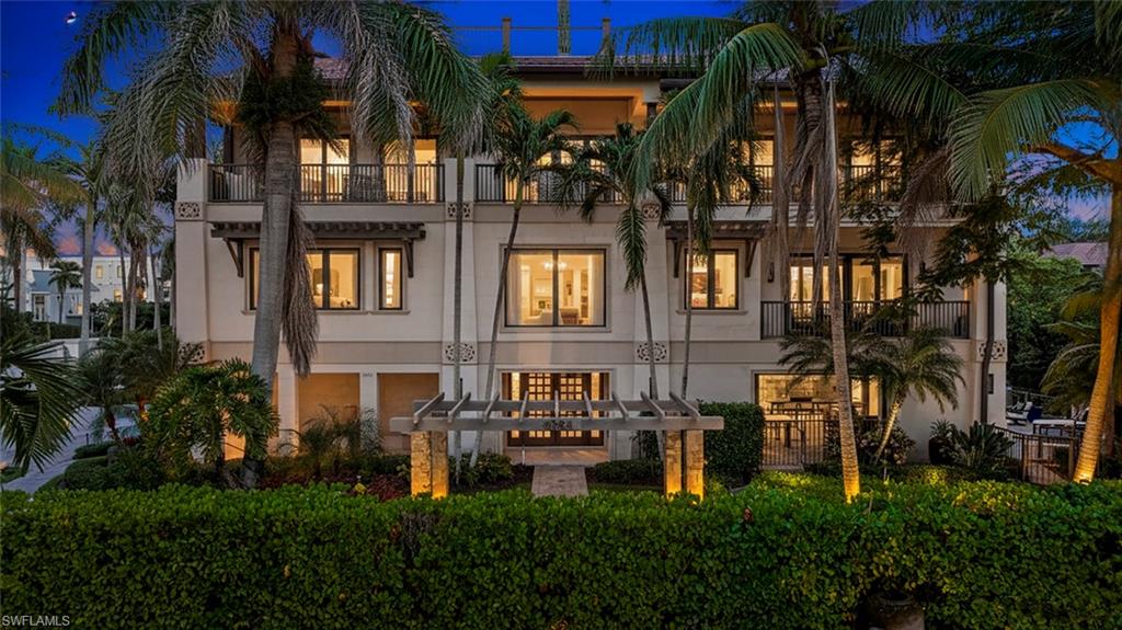 Back on market, buyer did not perform. The perfect location in Old Naples, just one block from the beach and two blocks from the fine dining and boutiques of Third Street South. This exceptional all-concrete custom home crafted by Grand Bay Development embodies the best of Naples' luxury living. Built to a 15 foot elevation for peace of mind. Featuring 5 bedrooms, 2 dens, plus a flex room off of the pool area and 5 & 1/2 bathrooms.  Every detail reflects a commitment to world-class design and craftsmanship, from the curated global finishes to the tropical connection between indoor and outdoor living.
The gourmet kitchen adorned with Cristallo Quartzite serves as the heart of the home, with beautiful hardwoods that are increasingly rare, and surrounded by spectacular greenery that creates a sense of privacy and retreat. A custom quartz and agate wet bar opens to the elegant great room, where walls of glass frame western facing terraces. The primary suite offers an elevated sense of serenity with a private balcony with partial gulf views. 
A rooftop terrace provides panoramic views of the coastline, breathtaking sunsets, and the Naples skyline. The southwest-facing lanai features a vanishing-edge saltwater pool, expansive covered entertaining areas protected by screens and shutters, and meticulously designed tropical landscaping. Combining architectural integrity, global inspiration, and an unmatched location, this residence defines a warm and inviting luxury along the Naples coast.