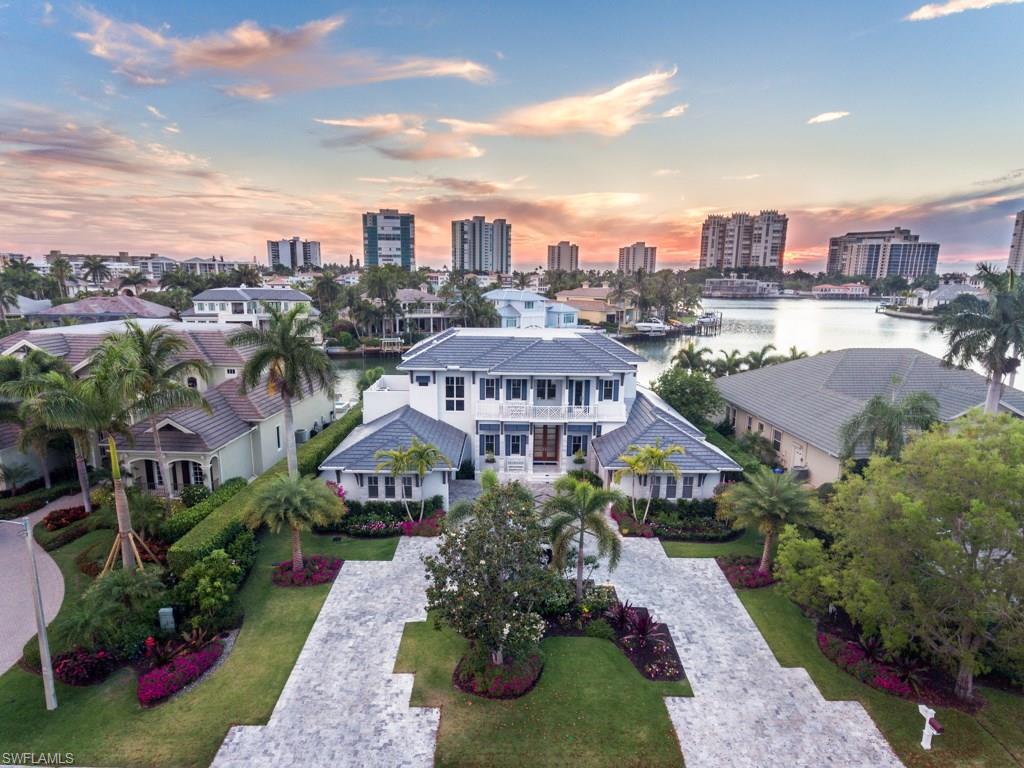 An exceptional new waterfront retreat combining wide water views, sunset western exposure and impeccable quality deliver Park Shore's finest new waterfront residence. The soaring ceilings and two story open floor plan perfectly frame the vistas of Venetian Bay. State of the art features and finishes throughout showcase the style, luxury and convenience, Sonos A/V systems, exotic stones, custom marble baths, sauna, and other luxurious selections. Wolf and Sub Zero, double ovens, Asko dual dishwashers, and option of induction or gas cooking in the kitchen. Wide oak wood floors throughout and Calacatta Gold Premium slabs draped over the island. Prewired for automation. Sensational outdoor living is achieved with rare marble decking, outdoor shower, pool bath, custom spa, expansive covered entertaining areas, with summer kitchen, multiple beer taps, and shutter systems for protection while away. The new sea wall, dock and boat lift complete this waterfront masterpiece making it ideal for entertaining and a quick boat ride to the Gulf. A truly breathtaking vacation retreat without rival in one of Naples' finest waterfront communities, Park Shore, including resident only beach park.