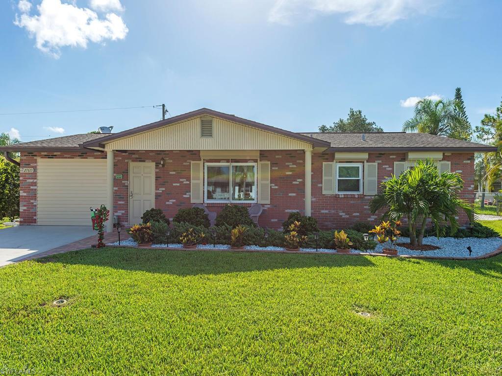 H.10896 - Beautifully maintained and updated home 5 minutes to the beach!  Super energy efficient hurricane rated double pane windows in 9/15, cost over $12k; plus storm shutters! Renovated kitchen and master bath 2015; Solid maple cabinets, crown molding, and under cabinet lighting; quartz countertops; tumbled stone backsplash; center island and newer appliances. Solatube for lots of natural light; open and spacious dining area; Two sided fireplace to enjoy from both the kitchen/dining and the living room! Extremely spacious and bright master bedroom with cozy corner, electric fireplace. Ikea built in storage in closets.  Master bath features quartz countertops with lovely trough style sink, frameless shower door. Large, solar heated pool with paver surround deck; separate hot tub overlooking back yard; new gutters and soffits 2013. Pool cage with small gauge ‘tough’ screen. Roof in excellent condition from 2009.  Just freshly painted throughout. Well water for lawn sprinkler system; Trane heat pump with 16 SEER rating. Security system; RV pad and storage shed.