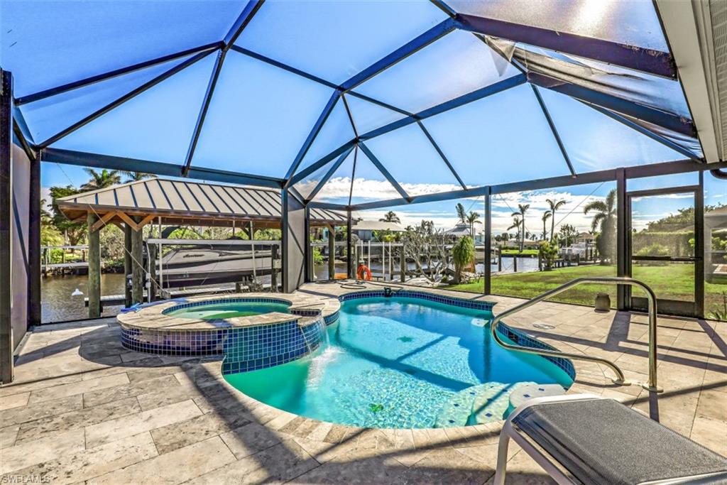 H8092- Much potential will be found at this fantastic waterfront location. Situated on one of the widest direct Gulf access canals in the area. Featuring a 100 X 125 lot with concrete seawall, metal roof boathouse with lift and a separate platform lift for personal water craft. Also, the expansive lanai and pool deck were just refurbished with travertine stone and features a picture window pool cage with freeform swimming pool and built-in hot tub/spa. The lanai is so inviting it's perfect for entertaining. With nearly 2600 square feet under air this spacious home offers 3 bedrooms, 3 full baths, 3 car garage and an all new roof, electric service and new central air. The home has been mitigated from the hurricane flood, a general contractor has been hired and building permits and renovations have begun. Price is subject to change as work is completed and is based on it's current "as is" condition.