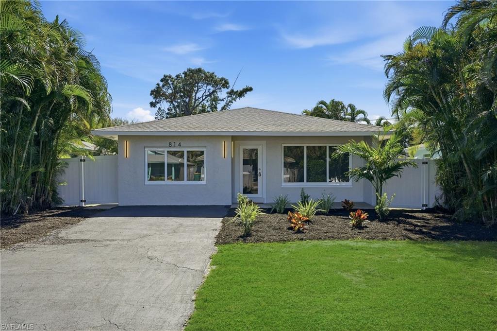 Nestled in the highly sought after neighborhood of Naples Park, this home pairs a prime location with effortless everyday living. With no HOA, enjoy lower monthly costs and greater flexibility for landscaping, parking, and excellent rental income potential. This home offers strong curb appeal, blending new and mature landscaping, while offering complete privacy from your neighbors. Step inside the beautifully remodeled 1,500 sq ft open concept home where thoughtful upgrades meet effortless style. All new electrical wiring and panel complement new plumbing in the bathrooms and kitchen, and light modern 10" x 70" tile visually expands the living spaces. The kitchen is a chef’s daydream with quartz countertops, stainless steel appliances, dovetailed drawers, and a special nook of built in cabinets that keep pantry clutter out of sight. Solid core interior doors, impact windows and doors, and a privacy glass front door as well as side door all deliver lasting quality and peace of mind. Relax in the serene primary bedroom that boasts an elegant ensuite with dual sinks, quartz countertop, and tempered 3/8" glass shower doors, then step through French doors of this bedroom onto a generous screened lanai — or slip outside from the great room French doors for easy indoor outdoor living. Practical touches elevate daily life: a laundry room with its own private exterior entrance as well as interior, wafer adjustable lighting and modern ceiling fans in every bedroom and the great room. The backyard is fully fenced with dual side gates and sits on a generous lot with ample space to add a pool, making this home a perfect blend of modern convenience, thoughtful design, and relaxed Florida living. With a brand-new roof installed in 2025 as well as a new water heater, this home offers true peace of mind and is just a two-mile bike ride or walk to the beach, with shopping, dining, and the Mercato all within five minutes from this exceptional property.