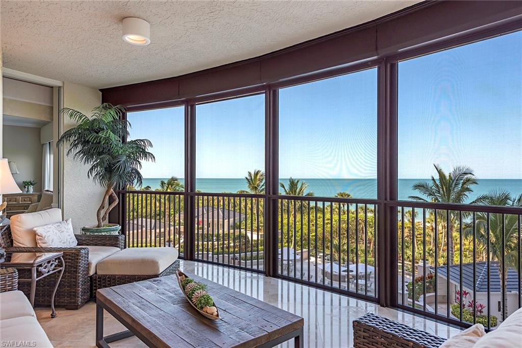Gorgeous Gulf and sunset views! Enjoy hearing the waves roll onto the sand from the spacious lanai of this meticulously maintained end unit residence directly on the beach in the private gated community of Bay Colony in Pelican Bay. Featuring panoramic views of the Gulf of Mexico through floor-to-ceiling sliding glass this highly sought after floor plan boasts upgraded Crema Marfil marble flooring throughout and newer appliances and AC. An elegant private elevator entry foyer welcomes you into an expansive living area boasting nine-foot ceilings, separate dining area, an eat in kitchen with tons of natural light and a tasteful coastal color palette. The Remington amenities include a gorgeous designer renovated lobby with 24-hour manned front desk, two guest suites, fitness center, social room, and a resort-style pool. Bay Colony residents enjoy the use of their own private newly renovated beach club and restaurant, Bay Colony tennis club, as well as the use of the amenities and additional two private beach clubs of Pelican Bay. Private golf memberships are available separately.
