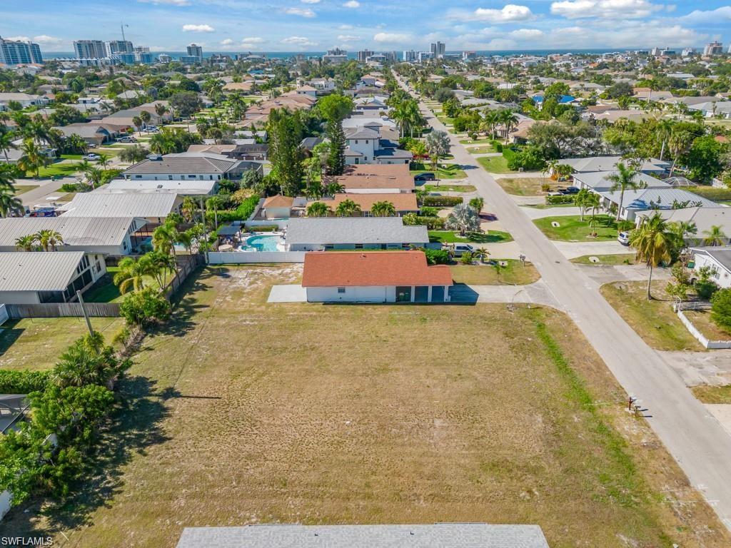 Discover a rare double-lot opportunity in the heart of Naples Park, one of North Naples' most desirable and flexible residential communities. With no HOA, this oversized 0.31 +/- acre parcel offers exceptional development potential - ideal for custom single-family home, duplex, or multi-family project. Located west of US41, the property sits just minutes from Vanderbilt Beach, Delnor-Wiggins Pass State Park, and the vibrant dining, shopping, and entertainment options at Mercato, Whole Foods, and nearby coastal got spots.
