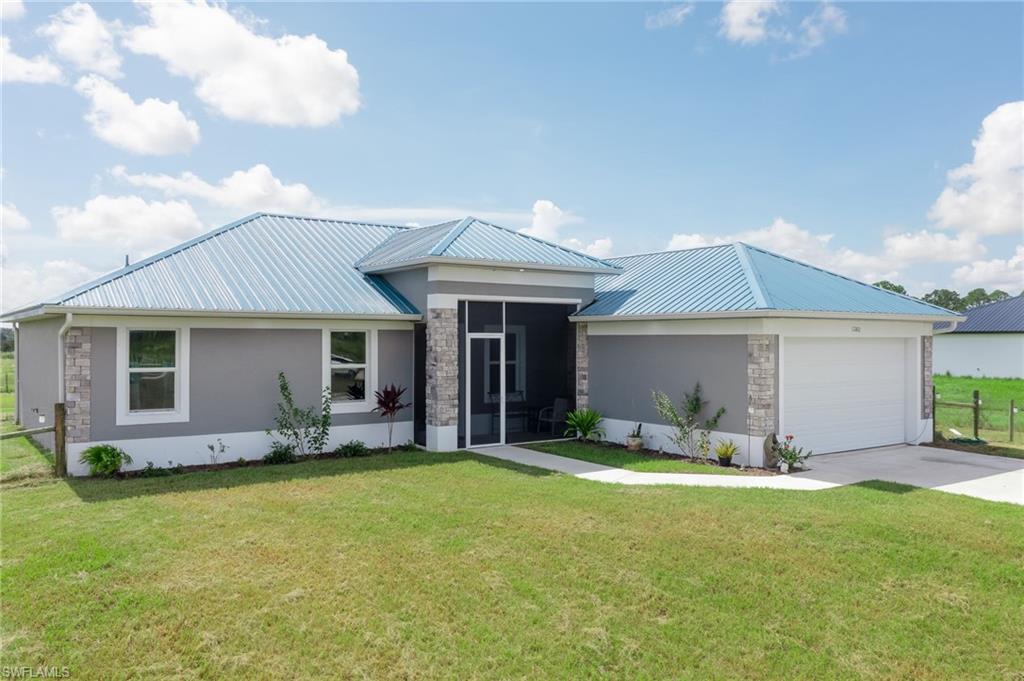This one-year-old home offers the perfect blend of comfort, convenience, and a touch of Florida living. Step inside to find a spacious, open-concept living area. The well-lit interior features abundant natural light, highlighting the neutral color palette and high ceilings. The kitchen is equipped with modern appliances, plenty of counter space, and an adjacent dining area. It's a functional space and perfect for entertaining. The house boasts 4 comfortable bedrooms that offer a peaceful retreat for rest and relaxation. The master suite features an ensuite bathroom and ample storage. Tile throughout the home provides low-maintenance flooring for kids and pets. A spacious 2-car garage offers protection for your vehicles and additional storage space. Enjoy your morning coffee on the screened back porch while soaking in the Florida sunshine. An oversized and fenced lot allows plenty of room to build a backyard oasis or lounge in the pool. If you've been dreaming of a charming single-story home in LaBelle, Florida, this property is a must-see. Don't miss the opportunity to make it your own and enjoy the serenity and beauty of this wonderful community. More info here: bit.ly/1260wren