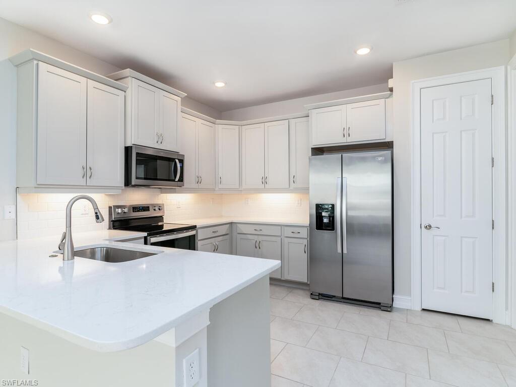 MOTIVATED SELLER!. Welcome home to this pristine & beautiful attached Villa in Enbrook. A new construction community is convenient to both Naples and Marco Island. This Villa boasts 2 Bedrooms PLUS a den/study allowing for plenty of space for you & your family. There is a generous size kitchen & dining area along with a spacious living room with access to the screened lanai. The master bedroom has its own en-suite bathroom and a walk-in closet. The 2nd bedroom is right next to the guest bath affording your guests privacy.  This unit has ceiling fans with remote controls in each bedroom, den & living room.  Quality window treatments have also been installed on all windows. There is a 2 car attached garage, with access directly into the home, a convenient laundry room off the kitchen, as well as a pantry in the kitchen, a keyless entry & smart home panel in the entry area. Enbrook is a gated community with a clubhouse including a catering kitchen, gym, pool & multiple pickleball courts. Enbrook is situated off of Manatee Rd providing several shopping, dining & beach options just minutes away. As a special bonus, this home has private lanai views as it backs up to the desirable preservation land section of the community.