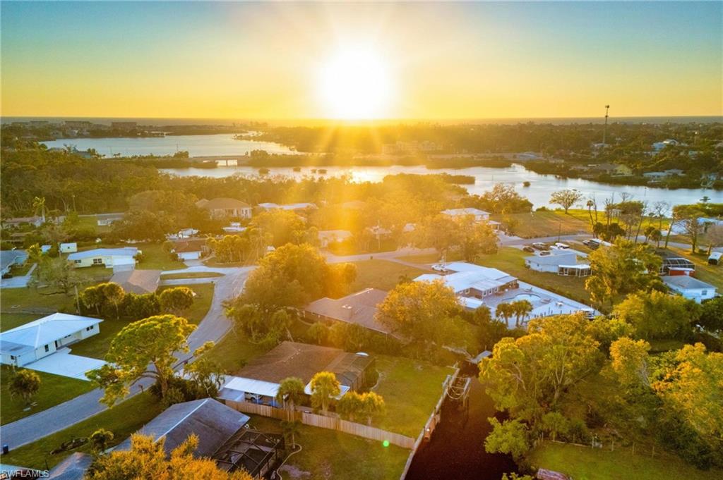 This special, one of a kind home has quick access to Dona Bay and then the beautiful ocean waters of the Gulf. This home is exceptionally elevated at more than 11 feet, keeping it high and dry and solid through storm season with zero flooding over the years. The inviting layout features 3 bedrooms, 3 bathrooms and a heated saltwater pool on a spacious, nearly half-acre lot shaded by stunning mature oaks and fruit trees. Interior highlights include fresh, light and bright paint, rich wood-look plank floors, vaulted ceilings, and a cozy woodburning indoor fireplace. The fully remodeled gourmet kitchen includes gorgeous Quartzite countertops, stainless appliances, solid-wood cabinets, built-in espresso maker, and a charming custom wine room for the wine connoisseur. Views of the relaxing pool deck with an outdoor kitchen from nearly every angle. The primary suite features pool access, custom walk-in closets, and a spa-like ensuite bath with a beautiful Spanish marble soaker tub, dual sinks and tiled shower. The split bedroom floorplan affords privacy and convenience for the second and third bedrooms, and the third bedroom features a private ensuite bathroom and pool access. The full guest bathroom also features pool access. The outdoor oasis includes a caged lanai with a saltwater, heated pool, outdoor kitchen, and a unique custom-built fire pit area. Follow the path to the dock and seawall, and imagine your own boat waiting to take you out for a fun day on the Gulf. Oversized 2-car garage has epoxy floors and upgraded modern storage cabinets with a tool bench. Truly a unique and charming waterfront escape located conveniently near historic downtown Venice, Venice Beach, Nokomis Beach, and Casey Key. Travel a short distance north for all of the amenities of Sarasota, including an exciting downtown district, Siesta Key Beach, performing arts venues, and luxury dining and shopping.