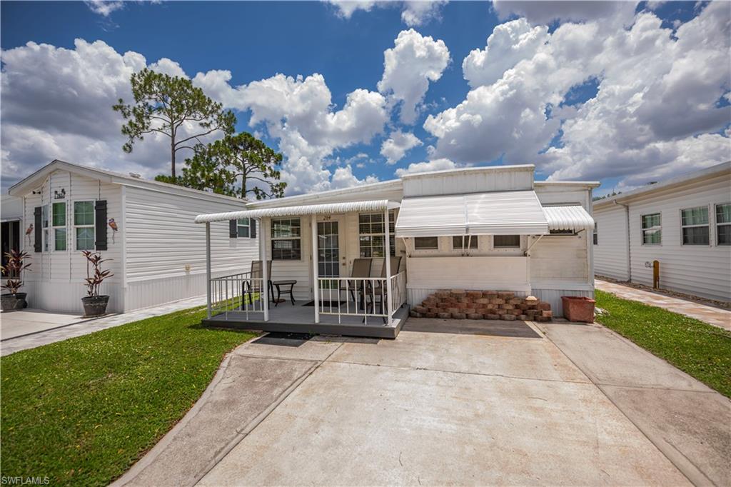 Located in the desirable Fountain View RV Resort, a well-established 55+ community where you own the land, this beautifully maintained turnkey-furnished 1-bedroom, 1.5-bath home offers approximately 748 square feet of comfortable living space. Designed for easy Florida living, the home features a spacious kitchen with abundant built-in cabinetry, an inviting living area, convenient in-residence laundry, and a functional floor plan that makes excellent use of space.  Enjoy peaceful outdoor living from the covered front porch overlooking open green space and mature trees, providing a relaxing setting to enjoy your morning coffee or evening breeze. The perimeter location offers added privacy with a small yard and fenced area, while clamshell awning shutters provide shade and storm protection. A new front awning installed in 2026 enhances both curb appeal and outdoor comfort. Residents of Fountain View RV Resort enjoy an active lifestyle with an impressive selection of amenities, including a clubhouse, community pool and spa, bocce, shuffleboard, tennis, volleyball, basketball, and optional RV and boat storage. Low HOA dues of just $264.50 per month include lawn and land maintenance, recreational facilities, and on-site management. Conveniently located just minutes from downtown Fort Myers, shopping, dining, medical facilities, golf courses, and Southwest Florida's beautiful beaches, this move-in-ready home offers an outstanding opportunity to enjoy affordable, maintenance-free Florida living.
