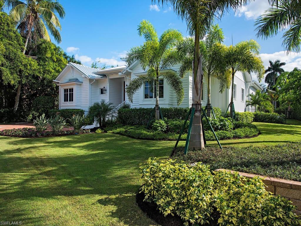 Perfection has arrived!  Unlike all the others, this home is unique in design, size and location.  Positioned on a coveted 100 x 150 lot with south exposure at 6th Avenue S. and Gulf Shore Blvd. S., the residence is 3 homes from the azure blue Gulf and 2 homes to the famed 5th Avenue S.  The desirable one floor living features a great room with an over-sized cupola streaming in sunshine from all directions and open to the resort atmosphere of the outdoor living.  As the open great room meets the kitchen, the captivating features of rare Azul Cielo coastal counters, Sub-Zero, and a beautiful Lacanche gas range invite the chef to make this home. The Outside Living Room where steaks are grilled by the fireplace, is open air or can be enclosed with glass doors, electric screens, or shutters.  A large pool and spa tiled in the softest Gulf blue create a relaxed beach atmosphere.  Generous en suite bedrooms are joyful; the den with window seat and bath is private. The cabana with its own entry provides guests or older children with a complete morning kitchen, but the breathtaking peek of the Gulf of Mexico is thrilling! Designer furnishings included!  And this completes the perfection.