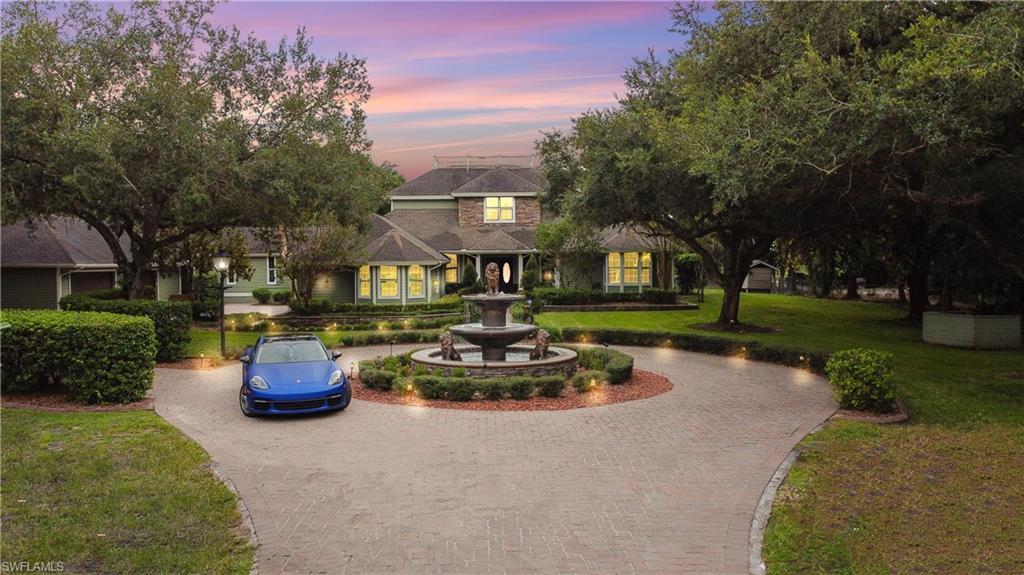 Welcome to one of Fort Myers’ most extraordinary private estates, where timeless craftsmanship, resort-style amenities, and unmatched privacy come together on 2.56 beautifully landscaped acres. Offering over 6,100 square feet of living space, this custom-built residence is designed for those who appreciate luxury, entertaining, and everyday comfort.

From the moment you arrive, the impressive circular paver driveway with its elegant fountain creates a grand first impression. Inside, you’ll find soaring ceilings, rich wood flooring, custom millwork, and expansive living spaces filled with natural light. The chef’s kitchen is a true centerpiece, featuring premium appliances, custom cabinetry, generous prep space, and seamless flow into the main living and dining areas—perfect for hosting everything from intimate dinners to large gatherings.

The spacious primary suite is a private retreat with a spa-inspired bathroom complete with dual vanities, a soaking tub, and oversized walk-in shower. Additional bedrooms provide comfort and privacy for family and guests, while a dedicated office, game room, and multiple flex spaces offer endless possibilities for work and recreation.

Step outside into your own private resort. The screened lanai features a sparkling pool, spa, outdoor kitchen, fireplace, and multiple covered seating areas, creating the ultimate space for year-round Florida living. Beyond the pool, enjoy your private tennis court, expansive green space, mature oak trees, playground, and room to relax or entertain on a grand scale.
This is more than a home—it’s a private luxury retreat offering the perfect balance of elegance, recreation, and tranquility, all while being just minutes from shopping, dining, RSW International Airport, and everything Fort Myers has to offer. Opportunities to own an estate of this caliber are rare. Schedule your private showing today and experience luxury living at its finest.