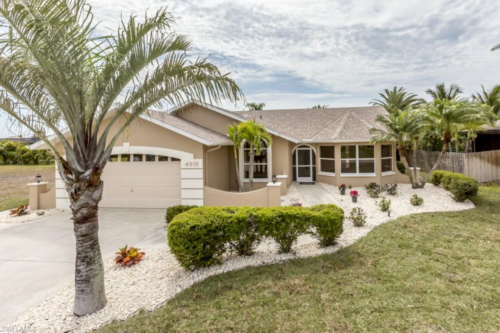 Beautifully redone 3/2 pool home in one of the nicest areas of Cape Coral!  Why buy new when you can have this completely updated home for far less.  The interior and exterior have been repainted and the landscaping updated with new sod.  The kitchen has been updated with Stainless Steel Amana appliances and granite countertops.  Both bathrooms have new tile, vanities, and fixtures.    The master bedroom has his and her closets and French doors that open to the resort like pool area.  The pool has an overflow spa and waterfall feature.  All bedrooms have new, upgraded carpeting and tall, vaulted ceiling.  Other updates include a new roof in 2014, new water heater, and new pool pump.  The master bath functions as the pool bath, there's a central vacuum, and the house has speakers in each room in the ceiling.  Compare to a new home, you won't be disappointed!