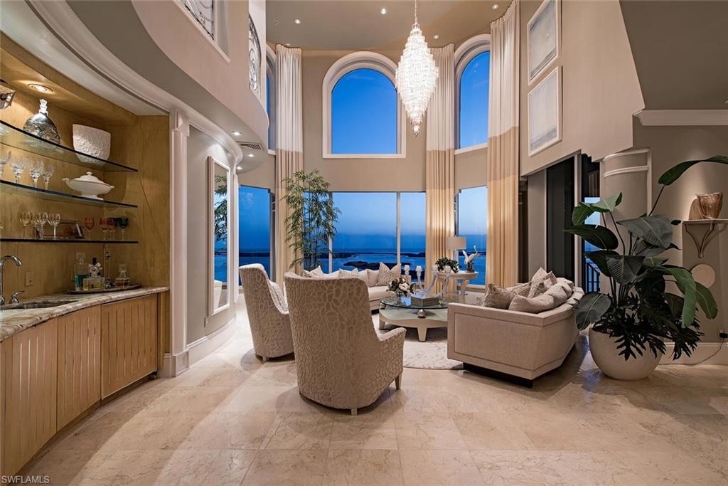 Breathtakingly beautiful two story 7300+ SF La Scala Penthouse  re-imagined  in 2017 by Clive Daniel Designs.  Soaring 20+foot high living room with walls of glass bring in completely un-obstructed Southwest views over Estero Bay and the Gulf of Mexico. A dream kitchen with multiple refrigerators, Wolf appliances 6-burner gas range and two sub zero wine towers with refrigerated drawers. Multiple outdoor terraces including summer kitchen with Gas grille.Customized furniture, moldings & built-ins with curvilinear ceiling treatments and book shelves.  Motorized hurricane shutters and window shades. Wood, glass and steel custom staircase built over cascading water feature or private elevator bring you to second level with balcony views.  The second level features a lavish  home theater, huge master suite with unique spa bath with curved vanities and views to the Gulf.  Outside,  a private spa surrounded by custom planters on your roof top terrace.  A large office with several customized bookcases completes this level.  2-Car private garage, 24 X 7 Front Desk and all the Colony Golf & Bay Club amenities await