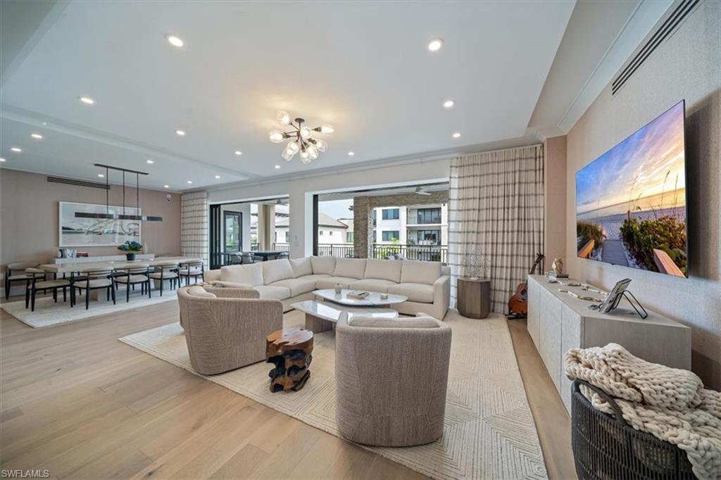 Welcome to residence 404 at Quattro which showcases the elegant “Bianca” open floor plan, featuring 4 bedrooms, a den, and 4.5 baths. Rarely lived in, this residence is the largest available, offering 3,437 square feet of air-conditioned space, a 438-square-foot balcony, and soaring 10-foot ceilings. The expansive 36-foot balcony faces east, providing stunning views of the meticulously landscaped courtyard and resort-style pool. Furnished with custom high-end pieces and designer lighting curated by a New York interior designer, no detail has been overlooked. The home boasts rich wide-plank hardwood floors, impact-resistant doors and windows, and a chef’s dream kitchen complete with a large quartz island, wet bar with wine cooler, and professional-grade Sub-Zero, Miele, and Wolf appliances, including natural gas cooking. Additional features include two deeded parking spaces in the gated garage, EV charging capabilities, and a climate-controlled storage unit. Quattro’s amenities are second to none, with a heated pool and spa, fire pit, outdoor pavilion with gas grills, a state-of-the-art fitness center, and a stylish clubroom equipped with a bar, terrace, large-screen TV, and billiards room. Located in the heart of Naples’ Design District, Quattro offers unparalleled access to Fifth Avenue South, Third Street South, and the pristine sugar-sand beaches. The vibrant Bayfront area with its restaurants and shops is just across the street, and the upcoming Gulfshore Playhouse is within walking distance. A masterpiece of British West Indies and Coastal Contemporary architecture, designed by the renowned MHK Architecture & Planning, Quattro is the crown jewel of Naples Square.