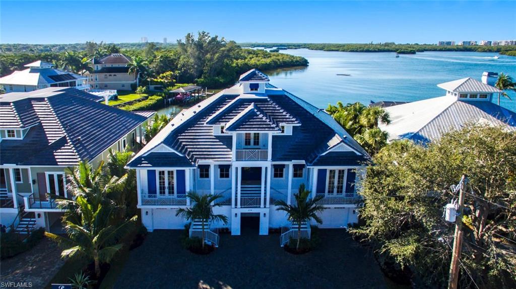 Bayfront new construction by Windover Development just completed. Embrace the appeal of 2017-construction with panoramic views of the open waters of Little Hickory Bay & highly-coveted Southwestern exposure for year-round sunsets. Easy Gulf access through Wiggins Pass from your brand-new boat dock. Fantastic North Naples/Collier County location minutes to fine shopping/dining & short bike ride to Barefoot Beach & Bonita Beach. Incredible Bayfront entertainment deck with infinity-edge pool, spa & fire pit. Gorgeous finishes throughout including volume ceilings with wood beam accent, granite, quartz & marble countertops, handcrafted designer lighting fixtures & large picture windows for optimal natural light. Gourmet chef’s kitchen with Thermador Professional series appliances, gas range, custom cabinetry & granite eat-in island. Fabulous open floor plan with multiple open air balconies, water views from every single room, & dual master suites—primary master suite with private Bayfront balcony, office nook, wet bar, huge California-style walk-in closet & spa-like bath. Additional features: Huge garage with space for four cars, private elevator to all floors & grand circular drive.