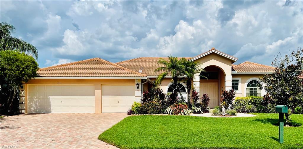 Welcome home to this lakefront beauty in Waterways of Naples! Surrounded by 150 acres of freshwater lakes, this gated community offers a large clubhouse, resort style pool, tennis/pickleball courts, basketball courts, tiki hut, tot-lot, fishing pier and much more! This 3 bedrooms, 2 full bathrooms home features a split floor plan and a master suite with tray ceilings and huge walk-in closets.  Its elegant double door entry, volume ceilings, and an abundance of natural light with 3 access points to the spacious, tiled screened lanai makes this home perfect for year-round indoor-outdoor living and entertaining. There is plenty of room in the backyard for a pool, if desired.
The kitchen has upgraded stainless steel appliances with the range and microwave purchased in 2022.  New tile roof and water heater were installed in 2018.  The professionally maintained landscaping is stunning. There is a community RV/boat storage area available that is gated and locked. The elementary, middle, and high school are all within walking distance; while the elementary and middle school are directly accessible from the Waterways Community. There is nearby shopping, dining, public golf courses, county park and just a short drive to Arthrex, Ave Maria and white-sand beaches.