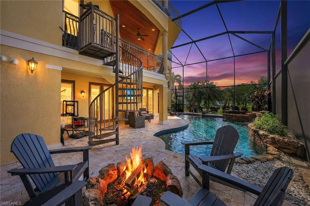 Welcome to the newest jewel of Imperial Shores—a masterfully appointed Gulf-access estate offering private dockage for two vessels and a quick 15 minute, seamless passage to the open waters of the Gulf of Mexico. This enclave is quietly evolving into one of the coast’s most coveted waterfront addresses, celebrated for its deep-water convenience and reserved seaside living.  Now unveiled for private viewing, this three-story residence is delivered beautifully furnished, embodying a rare fusion of maritime ease and architectural sophistication. Fourteen stately Royal Palms frame the exterior, while a sweeping circular drive accommodates five to six vehicles with effortless grace. Generous storage and versatile living spaces on the first floor enhance both practicality and versitility.
A dramatic three-story foyer greets you upon entry, its vertical grandeur softened by natural light streaming through expansive panes of glass. A sculptural curved staircase leads to the primary living level, where floor-to-ceiling windows encircle the space, inviting the outdoors inward. The family room flows into an expansive lanai, creating an uninterrupted dialogue between interior refinement and coastal serenity. The kitchen is curated for both epicurean artistry and entertaining, appointed with professional-grade KitchenAid gas appliances, custom deaigned cabinetry, a full-size wine cooler, and a suite of elevated finishes. Marble tile floors beneath ten-inch moldings and intricate cast-iron railings, details that understated opulence. Impact glass throughout and elegant tray ceilings underscore the home’s commitment to both beauty and resilience. A private elevator services all levels, ensuring effortless movement throughout the home. Designed with thoughtful intention, guest suites are discreetly positioned on each floor, each featuring warm wood flooring, walk-in closets, and private baths bathed in natural light. The primary suite is a sanctuary unto itself—expansive, tranquil, and commanding. Its spa-inspired bath offers openness and exceptional in size, the walk-in closet has a defined water closet with bidet and secured space when needed.  Above, a fourth-floor iron-railed lanai presents a panoramic vantage point—a quiet aerie from which to savor Gulf breezes and painted sunsets.  Outdoors, a sun-drenched pool and spa with covered lanai create a private resort ambiance, complemented by playful water features. The cozy firepit invites intimate evenings beneath the coastal sky.  Moments from Bonita Beach and the shimmering Gulf of Mexico, this Imperial Shores residence captures the essence of stunning Florida mornings and quiet coastal evenings—where casual sophistication meets the rhythm of the sea. Home Feature Sheet Attached or upon request.