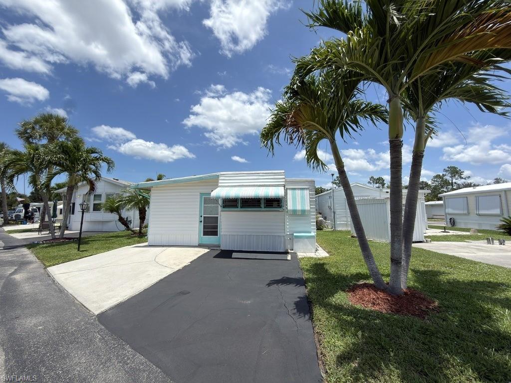Welcome to Enchanting Shores! This 2-bedroom, 2-bathroom property gives you the opportunity to get in at the lowest price point of any manufactured home currently available in the 34114 zip code. This property at this price-point, offers you the flexibility to move in and make it your own, or remove the existing structure entirely and place a new manufactured home or RV on the lot. The community is perfect for active residents, offering low-cost living with minimal monthly dues and a wide range of amenities, including a boat launch, community pool, tennis courts, bocce ball, pickleball courts and more! Whether you enjoy socializing or staying active, there's something for everyone. Indirect Gulf access via the canal means you're a boat ride away from Keewaydin Island on any given afternoon. For a nominal fee of just $180 per year, you can store your boat right on-site, making it easy & inexpensive to take advantage of the area’s incredible waterways. Tucked between Naples and Marco Island, you're close enough to Fifth Avenue for dinner or a night out, and within easy reach of some of the best beaches in Southwest Florida. Whether you're looking to renovate or build a new mobile home or RV, this property offers flexibility and great value in a prime location, making it a smart investment in Southwest Florida's thriving boating community.