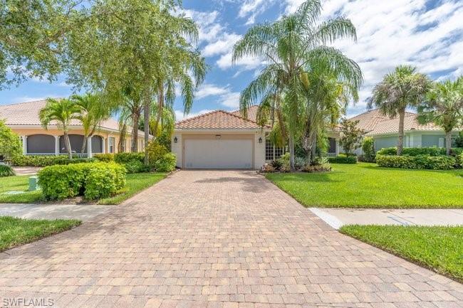 Sleek and contemporary best describes this four bedrooms plus den/ three and a half bath, original DiVosta, extended Carlyle, single family home. Conveniently located in the gated community of VeronaWalk in East Naples, all the updates are in place for a move in ready experience.
The home boasts three entertaining areas (one with coffered ceilings) perfect for hosting company. One room has a feature wall that holds a fireplace and large TV flanked by backlit shelving. Floors are tile throughout, plantation shutters shade the windows and the ceilings have stylish lighting and fan fixtures. 
An updated kitchen with abundant cabinetry has stone counters, tile backsplash and newer stainless appliances. The baths have all been updated with stone topped vanities, custom tile in the showers, seamless glass shower enclosures and modern mirrors. A deep soaking tub in the primary suite bath adds a statement piece.
This home has a newer roof for years of worry free living from weather. Accordion hurricane shutters allow you to always be storm ready. The expansive, air conditioned, two car garage opens into a full laundry room with additional storage and granite counters.
Your outdoor screen enclosed, tile patio has an inviting pool with spa and water fountains. A stone covered privacy wall adds texture to the lanai area. Cook up a tasty meal in your outdoor kitchen then relax by the firepit with a cocktail. A retractable awning allows you to enjoy both sun or shade. Being offered furnished, this can be a great year-round home or Florida escape.