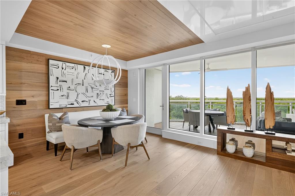 Experience elevated coastal living in this fully furnished, designer-appointed condominium in the prestigious Kalea Bay community of North Naples. This former award-winning model by W Designs showcases the pinnacle of luxurious craftsmanship and attention to detail, with every finish and furnishing carefully curated to perfection. From the moment you enter, you're greeted by rich wood flooring, dramatic custom built-ins, and designer furnishings that exude timeless elegance. The gourmet kitchen is outfitted with top-of-the-line Wolf and Sub-Zero appliances, including a Sub-Zero wine fridge, sleek quartz countertops, and refined cabinetry—an entertainer’s dream. The residence boasts a sprawling wraparound balcony offering panoramic views and seamless indoor-outdoor living, perfect for enjoying Florida’s breathtaking sunsets and coastal breezes. Every inch of this home reflects sophisticated design and functionality, making it truly one of a kind. Kalea Bay’s resort-style amenities redefine luxury, including a rooftop pool and sundeck, multiple sparkling pools, and a full-service clubhouse with formal and casual dining. Stay active with access to the state-of-the-art wellness center, tennis and pickleball courts, and private beach park. Additional amenities include fire pits, a dog park, and guest villas for visiting friends and family. Ideally located just minutes from upscale shopping, world-class dining, and championship golf courses, this exceptional property offers a rare opportunity to own in Naples' most sought-after waterfront community. Offered fully furnished and move-in ready—this is luxury living without compromise.