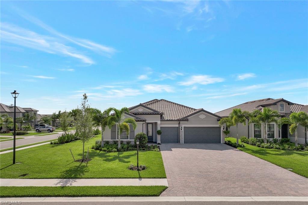 This stunning home is packed with upgrades and located in one of Florida's most desirable and sought-after communities, The Place at Corkscrew. As you enter this beautiful Creekview floorplan, you will notice the upgraded raised ceilings and an abundance of natural light.The open floor plan provides a seamless flow from room to room, making it ideal for both entertaining and everyday living.The spacious kitchen features built-in appliances, custom cabinetry, and large center island that serves as a focal point for gatherings. Step outside onto the expansive patio, where you can relax next to the custom salt water pool or unwind in the hottub.This home boasts 3 bedrooms and a den, one guest BR has an en suite bathroom and huge walk in closet. 4ft garage extension,epoxy coated garage, quartz countertops in kitchen & baths, outdoor kitchen is pre-plumbed, 8ft interior doors and more. Feel like you are on vacation everyday, whether it's the community restaurant/bar, resort style pool with waterslide, fitness center, or pickleball courts, there is something for everyone of all ages to enjoy. Furniture and golf cart may be sold on a separate bill of sale.